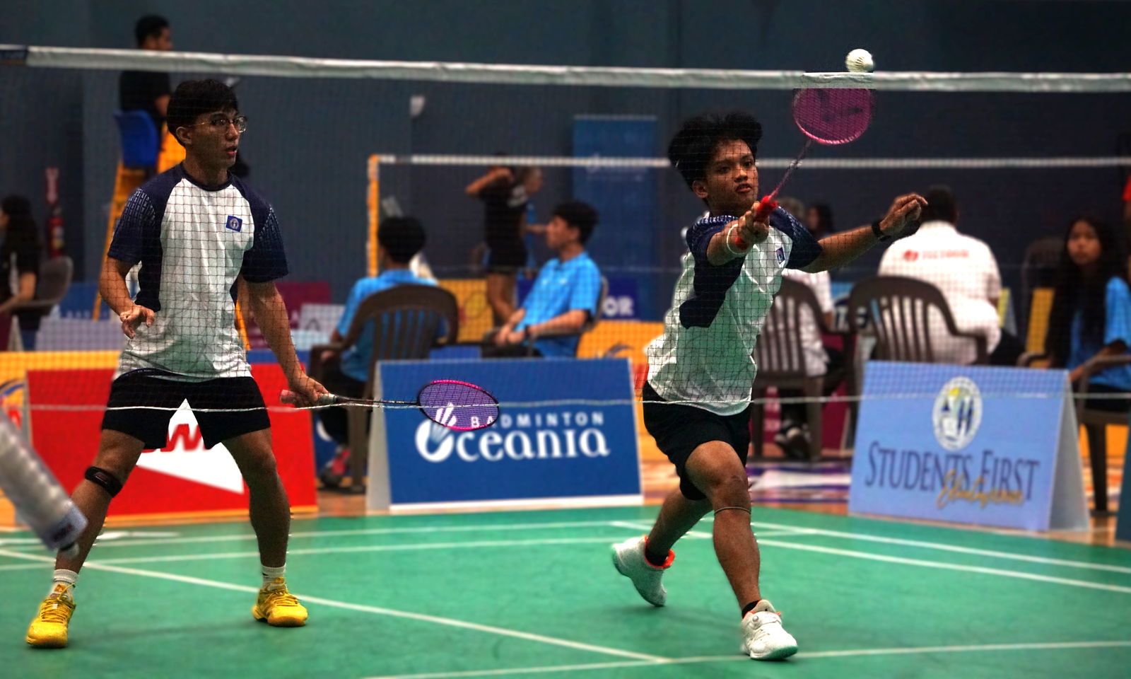 The NMI's Jude Mallari extends for the quick return alongside teammate Dave Odicta during a men's doubles match against Guam in the VICTOR Oceania Junior Team Championships 2025 at the Ada gym on Tuesday.Photo by James F. Sablan Jr.
