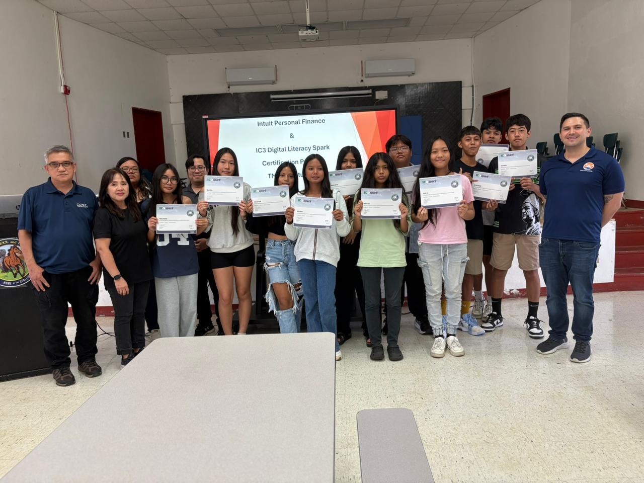 The Tinian Middle School IC3 Spark Section 1 students pose for a photo with Island Training Solutions Chief Operating Officer Alex Hu, right, and ITS instructor Arnel Gruspe, left.Contributed photo