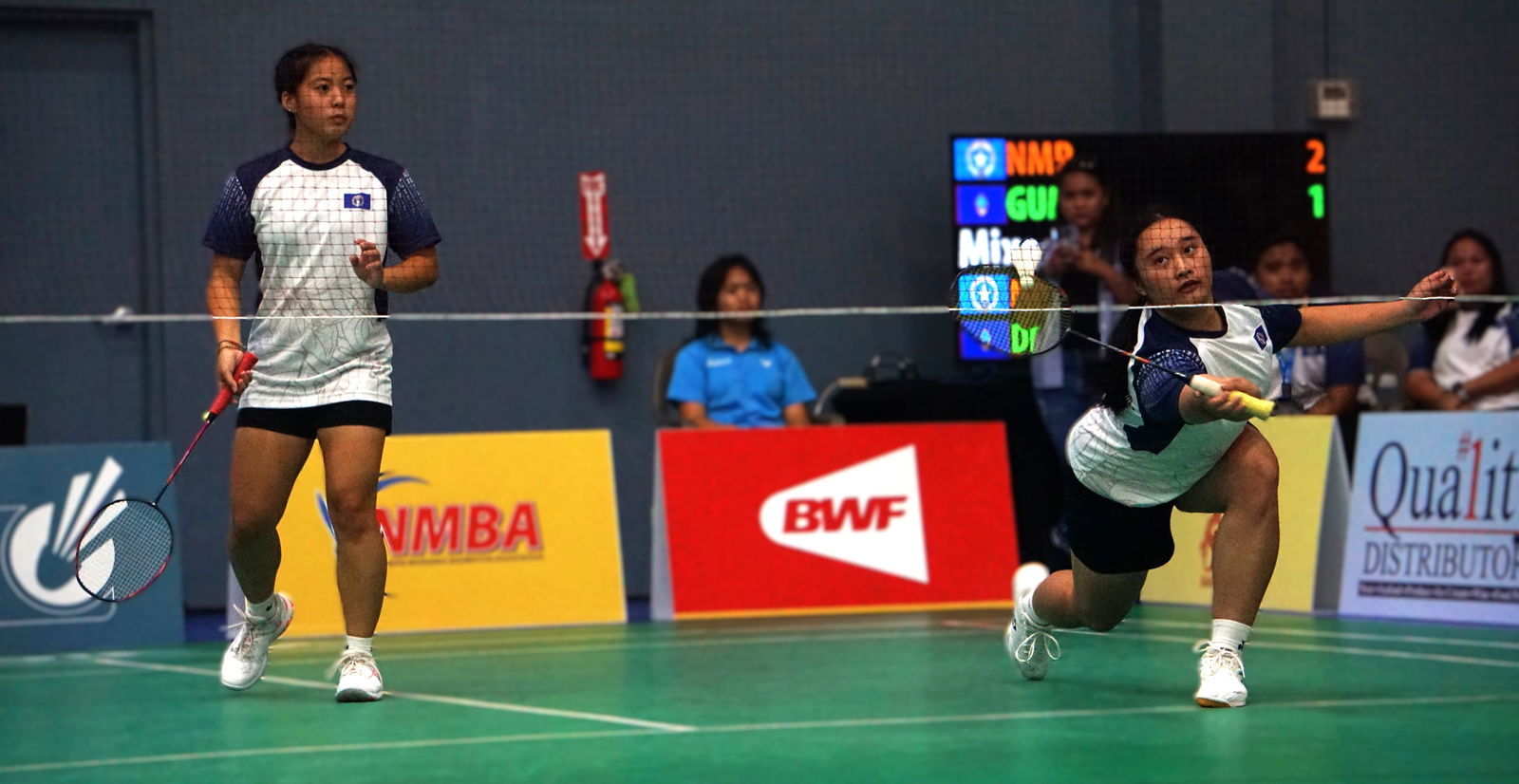 The NMI's Shaina Malonzo reaches out for the save with Lina Tsukagoshi during a women's doubles match against Guam in the VICTOR Oceania Junior Team Championships 2025 at the Ada gym on Tuesday.Photo by James F. Sablan Jr.