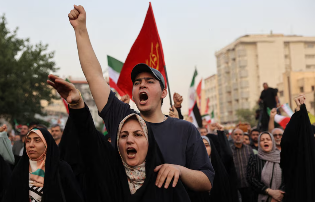 People gesture as they attend a gathering to support Iran's Armed Forces, after President Donald Trump announced a ceasefire between Israel and Iran, in Tehran, Iran, June 24, 2025.Photo by Majid Asgaripour/West Asia News Agency via REUTERS2 BD CENTER