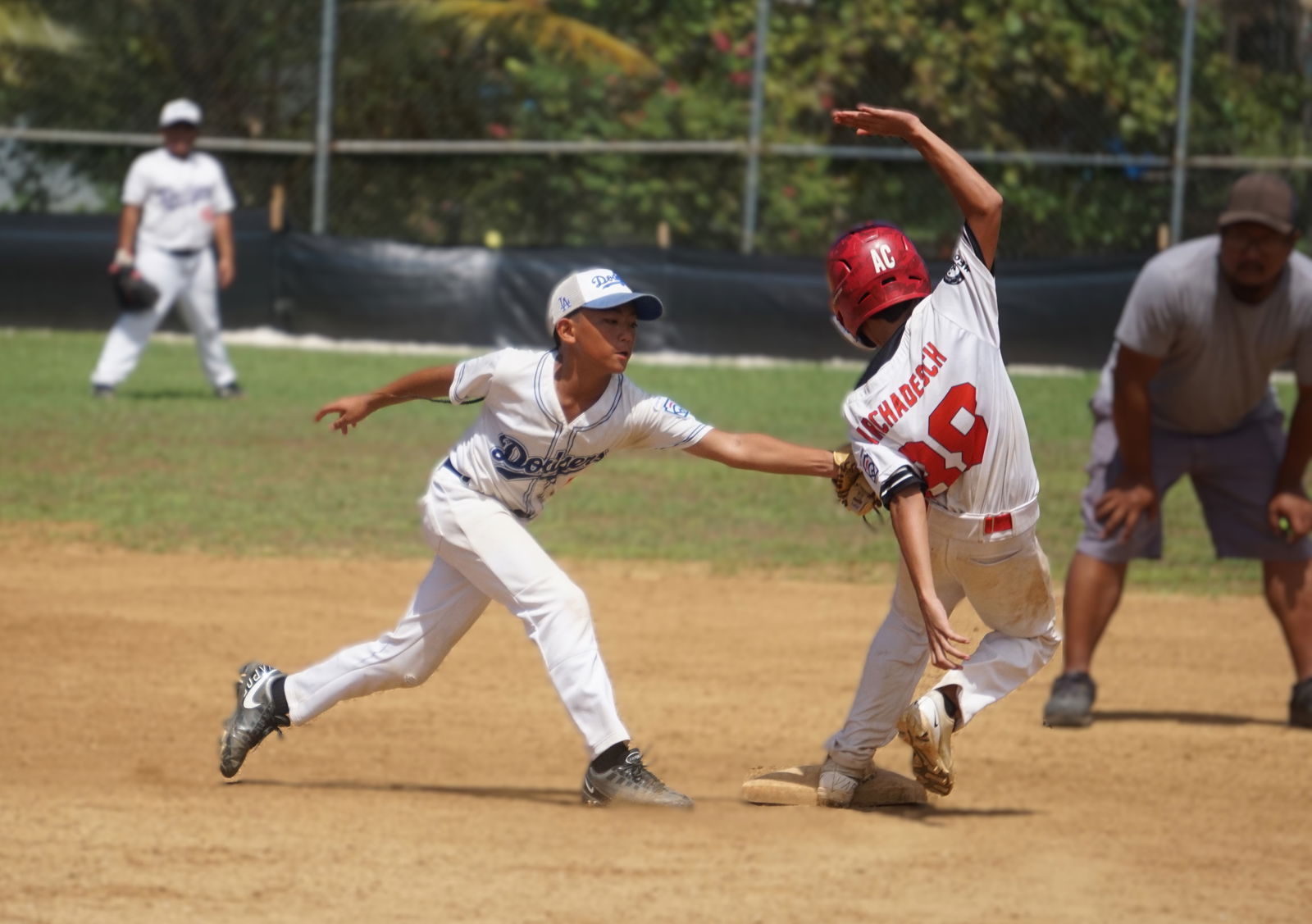 Dodgers second baseman Joshua McDonald attempts to pick off a runner at second base during the title game against the Braves in the major division of the 2025 Saipan Little League Baseball tournament at Miguel "Tan Ge" Pangelinan Ballfield on Sunday.Photo by James F. Sablan Jr.