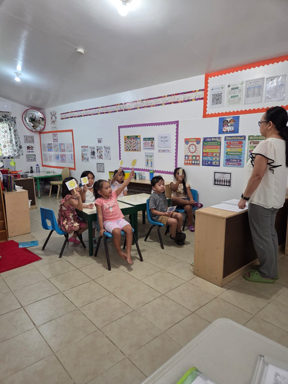 Students engage in identifying positive emotion scenarios presented by their teacher.