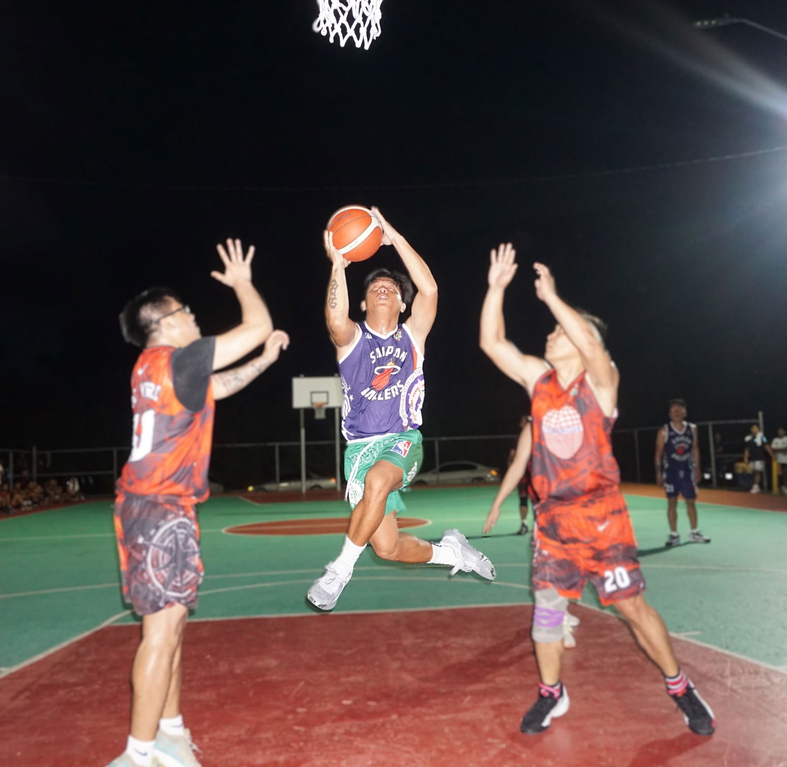 Saipan Ballers’ Rotap takes the off-balanced shot between two defenders during a game against Seabridge in the B Division of the E-Sports CNMI Invitational Basketball League 2025 at the Koblerville basketball court on Wednesday night.Photo by James F. Sablan Jr.