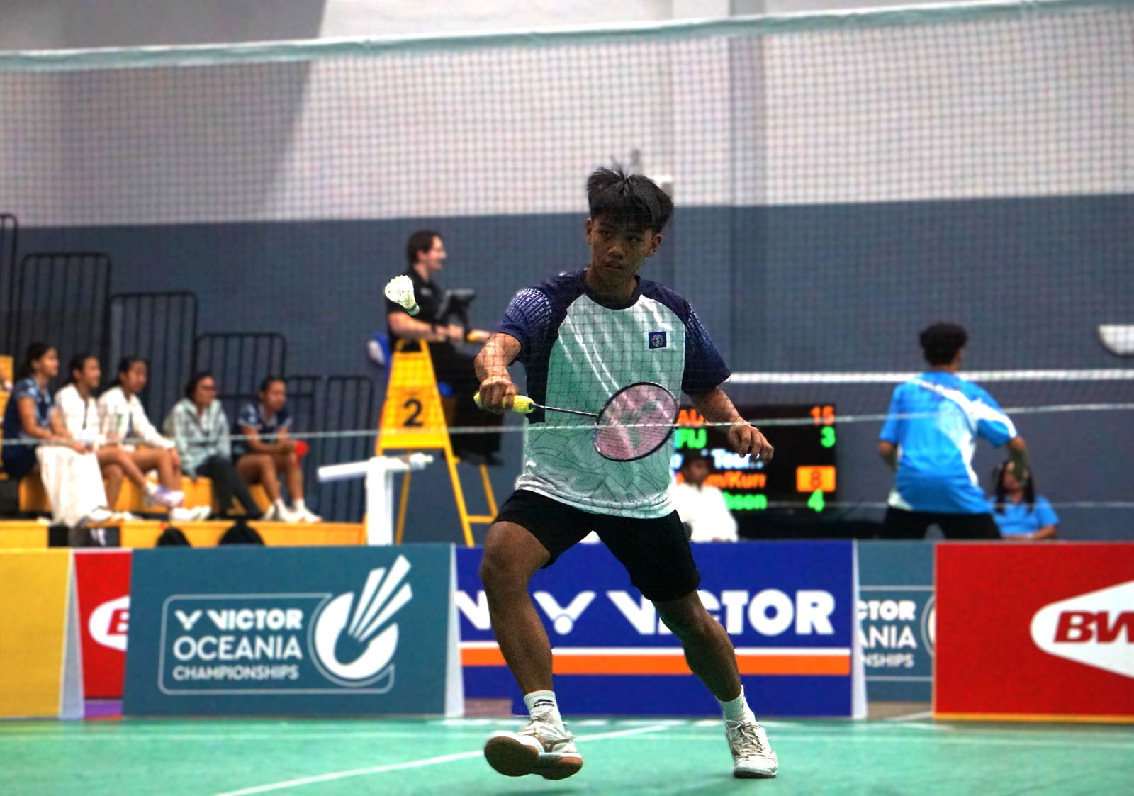 The NMI's Marlon Bautista reaches for the backhand return during a VICTOR Oceania Junior Team Championships match at the Ada gym.Photo by James F. Sablan Jr.