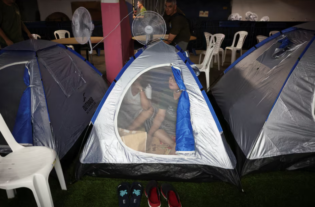 A migrant family from the Philippines prepares to spend the night in an old nuclear shelter under Tel Aviv's central bus station in the southern area of the city, recommissioned by Israeli volunteers Brothers and Sisters in Arms, amid the Iran-Israel conflict, in Tel Aviv, Israel, June 20, 2025.REUTERS