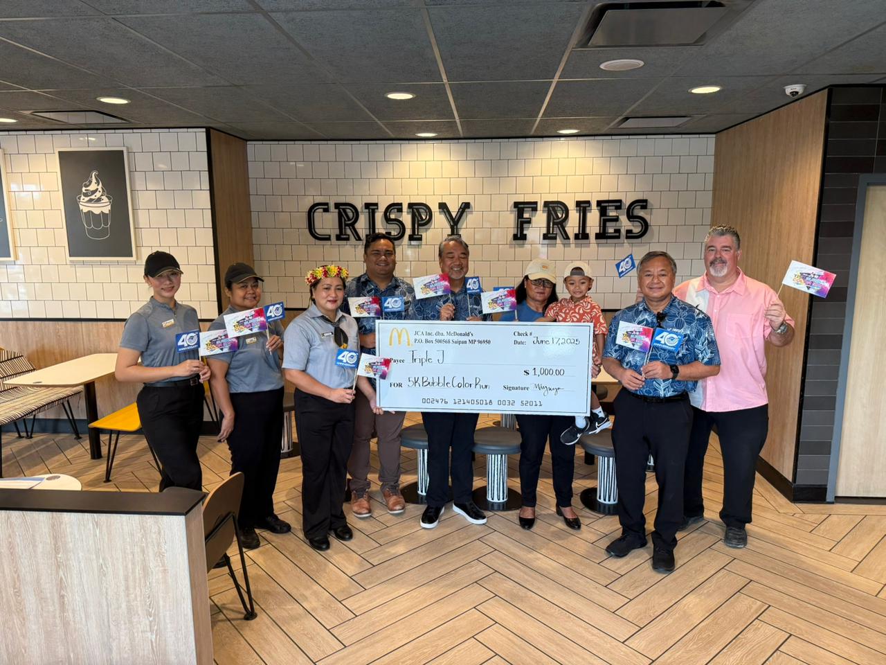 McDonald’s of Saipan & Guam Vice President Marcia Ayuyu and her staff pose for a photo with Triple J Enterprises officials, led by Vice President Mike Sablan, after making a $1,000 donation as silver sponsor of the 2025 Triple J 5K Bubble Color Run at McDonald’s Middle Road on Tuesday.Contributed photo