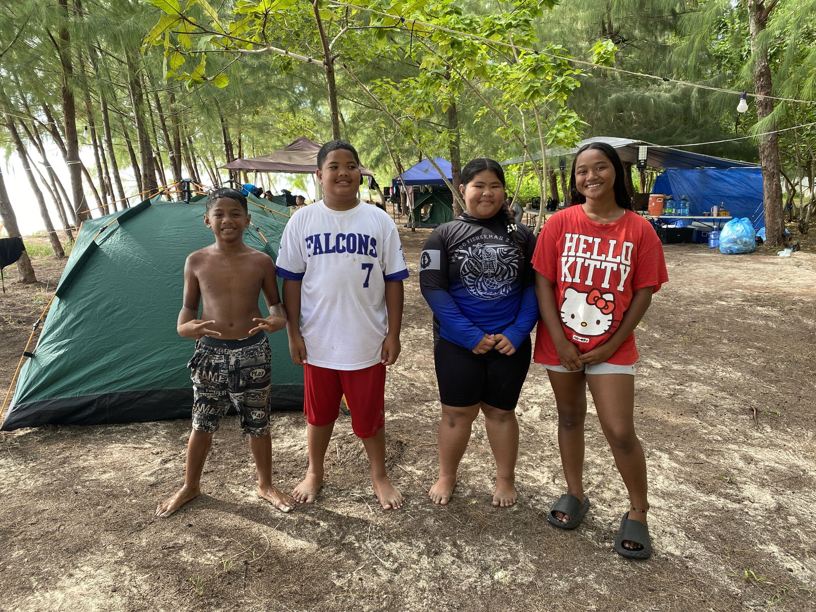 Aschuupi Lisua of San Vicente Elementary School, Ezekiel Taman of Kagman Elementary School, Riri Lisua of Oleai Elementary School, and Kyuwi Lisua of Dandan Middle School pose for a photo outside the tent where dozens of baby turtles were seen scuttling across their campsite. 