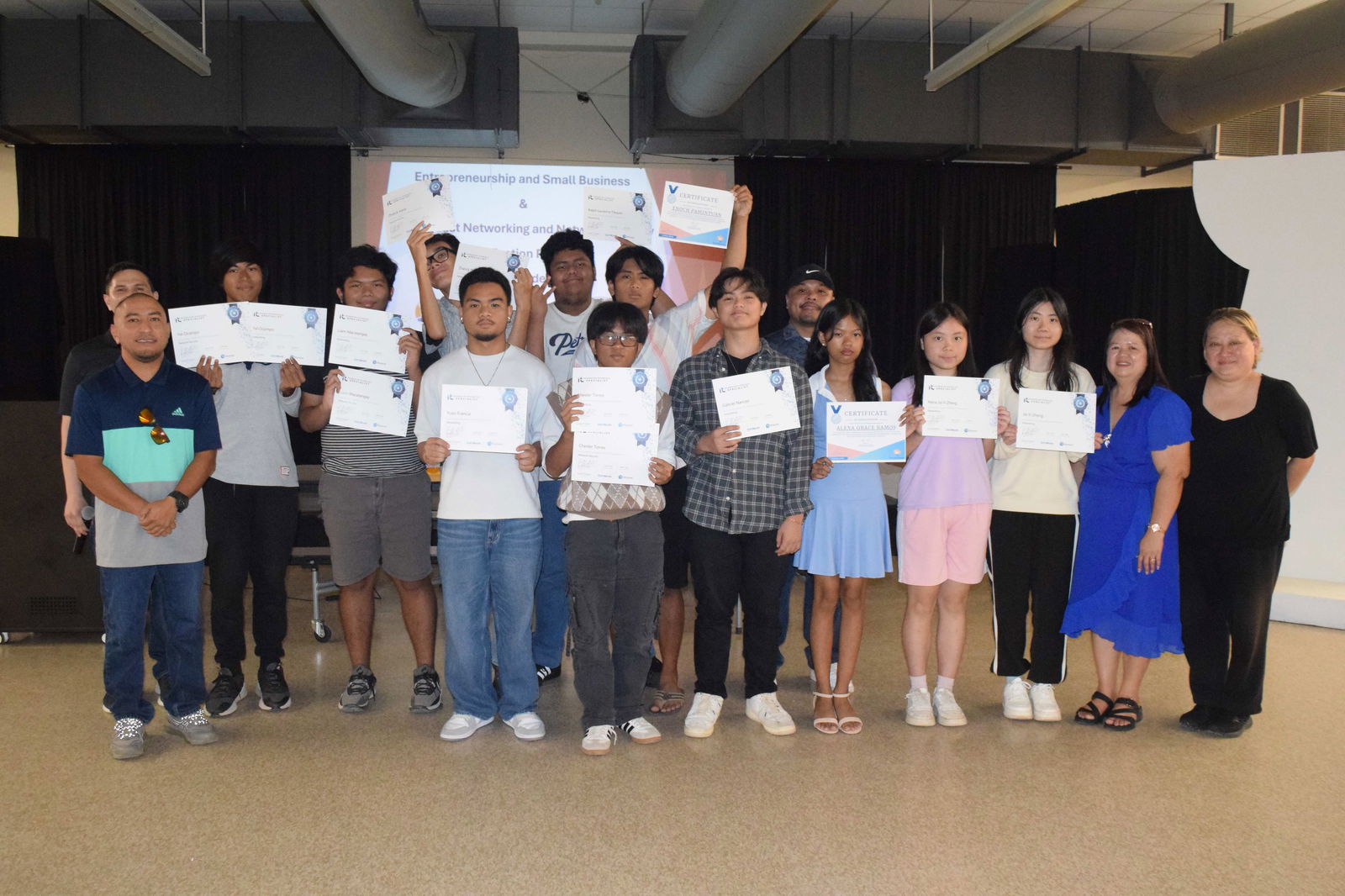 Thirteen of the 17 MHS students who completed the IT Specialist Networking and Network Security certification course pose for a photo with Public School System Senior Director for Curriculum and Instructional Services Dr. Rizalina Liwag, PSS Career and Technical Education Program Manager Jessica Taylor, MHS Vice Principal Preston Basa, Island Training Solutions Chief Operating Officer Alex Hu and ITS instructor Herman Kintol in the MHS cafeteria on Friday.