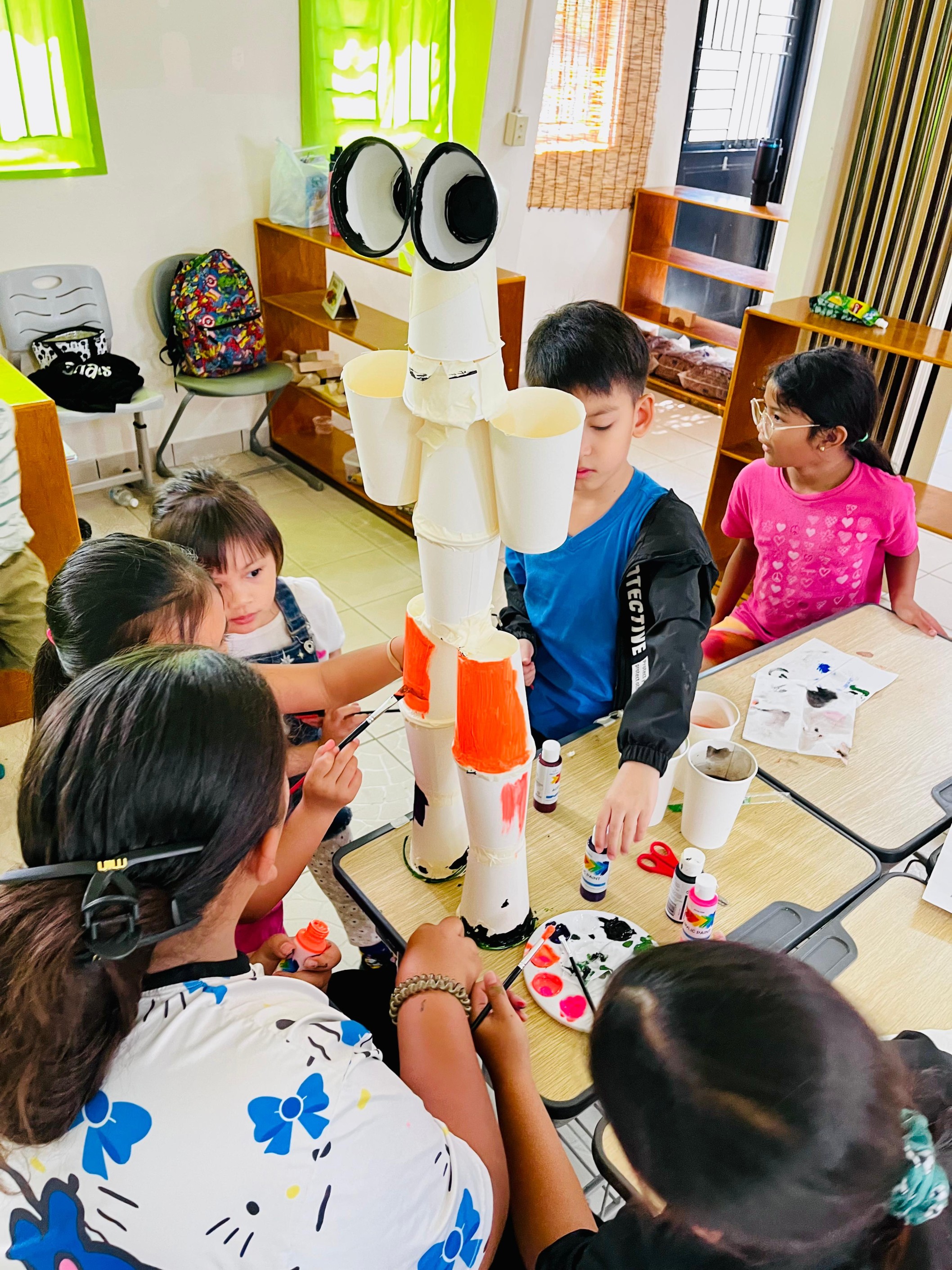 Creative campers focus on building their own robots during the Robot Making activity.