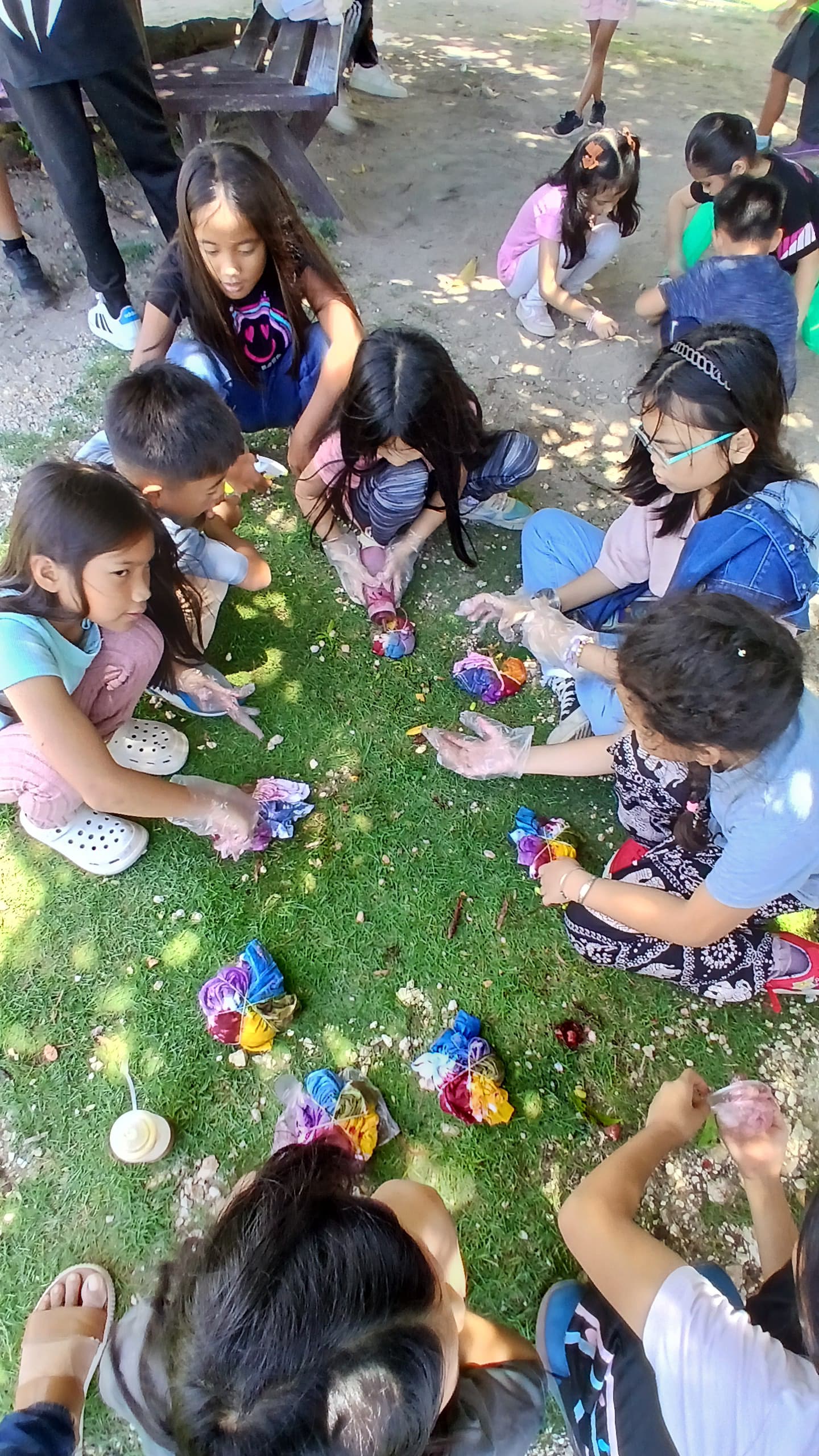 Art extravaganza: Campers enjoy a team-based T-shirt dyeing competition filled with color and creativity.