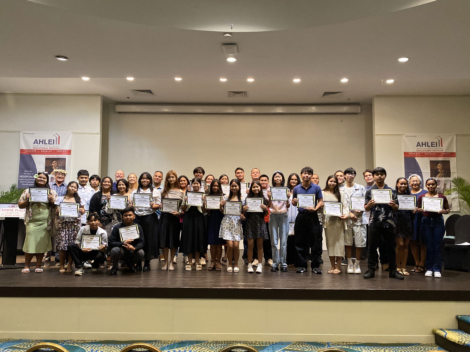 The students who passed the Trading Up: Hospitality course pose for a group photo.