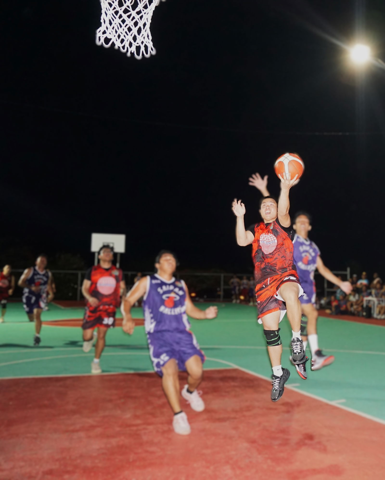Seabridge's Lance Lerio extends for the fastbreak finish during a game against Saipan Ballers in the B Division of the E-Sports CNMI Invitational Basketball League 2025 at the Koblerville basketball court on Wednesday night.Photo by James F. Sablan Jr.