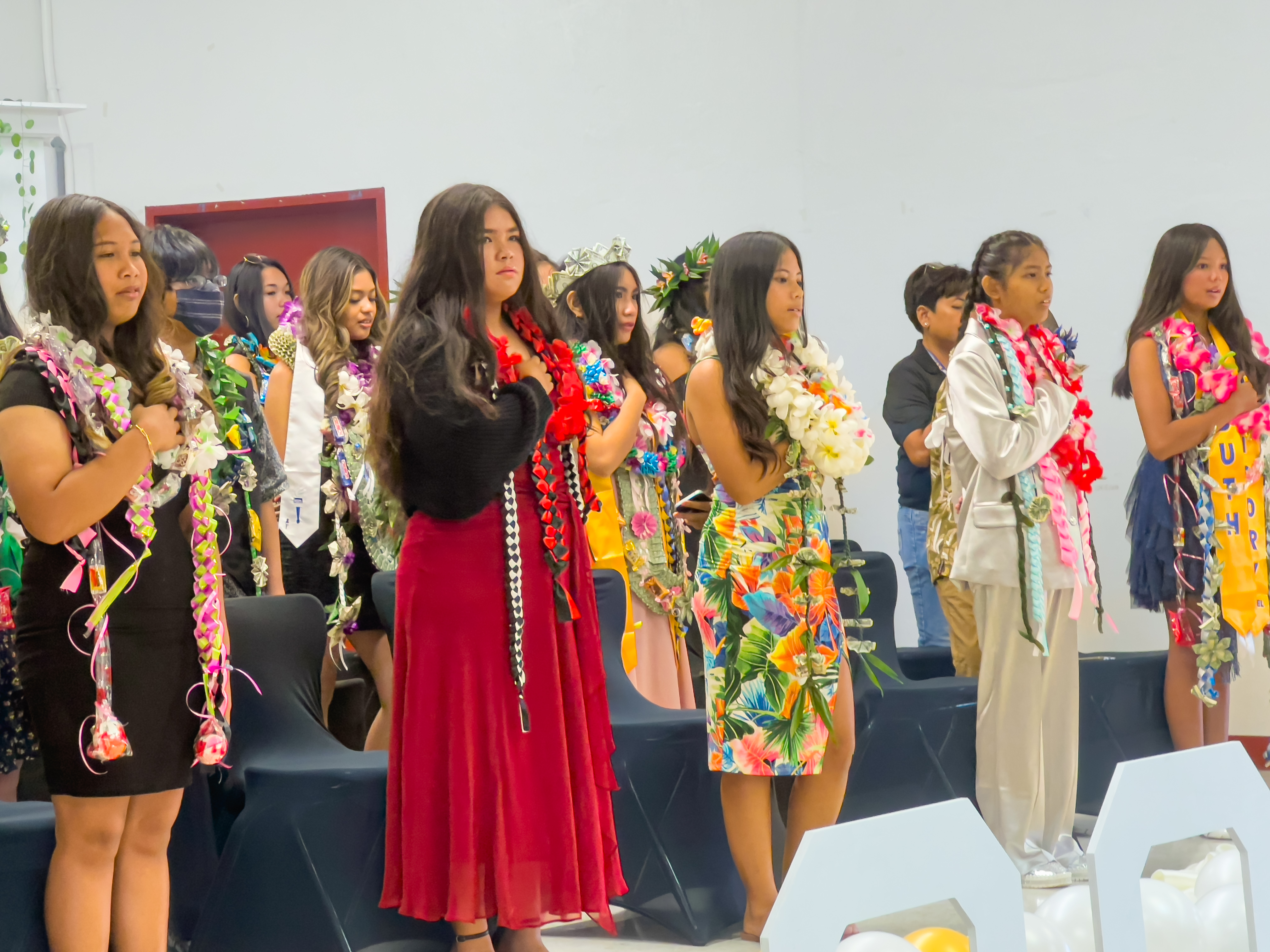 The promoted eighth graders sing the national anthem.