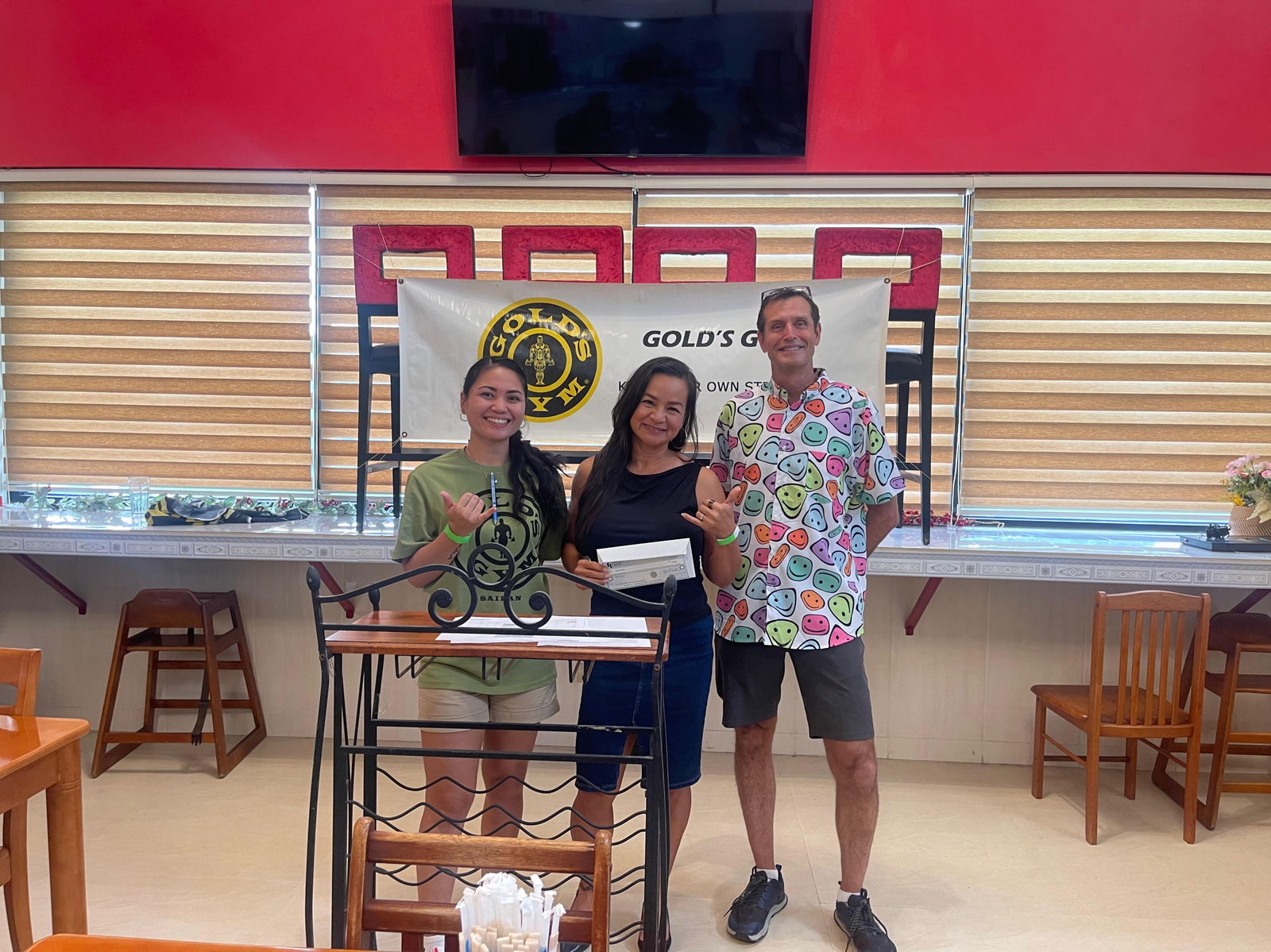 Women 50-59 winner Deanna Sablan with Gold’s Gym’s Tyce Mister and Michelle Masga.