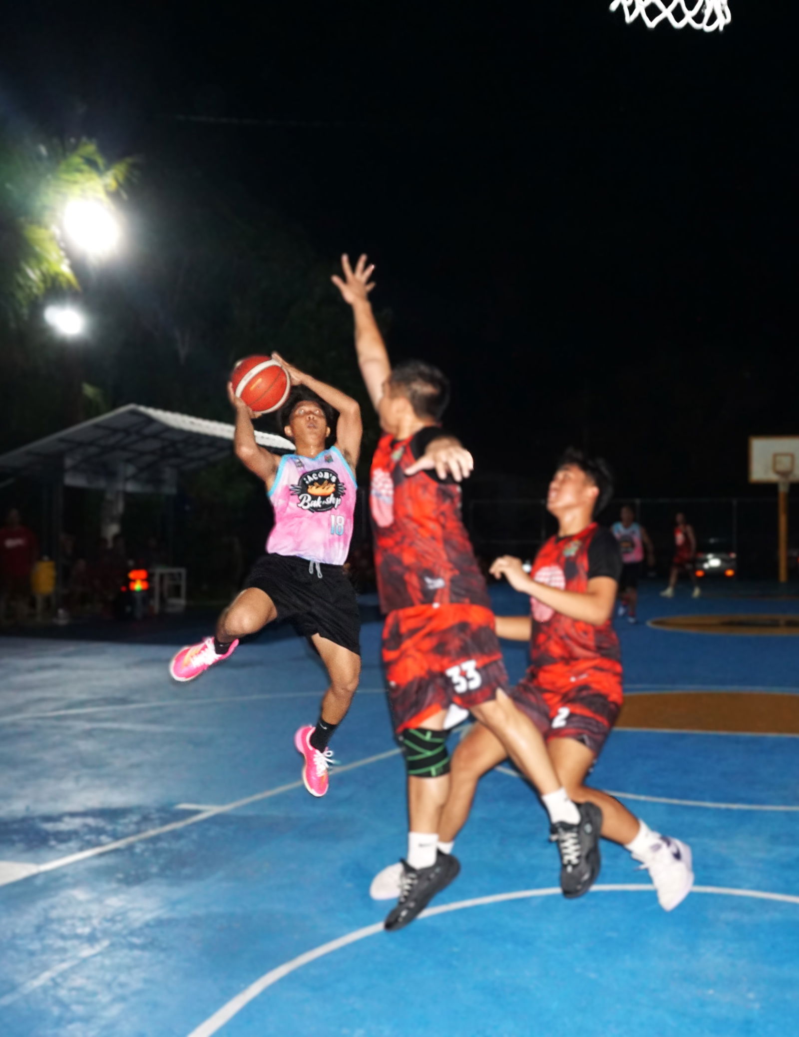 Jacob's Rjhay Singca draws the foul as he goes up for a layup during a game against Seabridge in the B Division of the E-Sports CNMI Invitational Basketball League 2025 at the Gualo Rai basketball court on Saturday.Photo by James F. Sablan Jr.