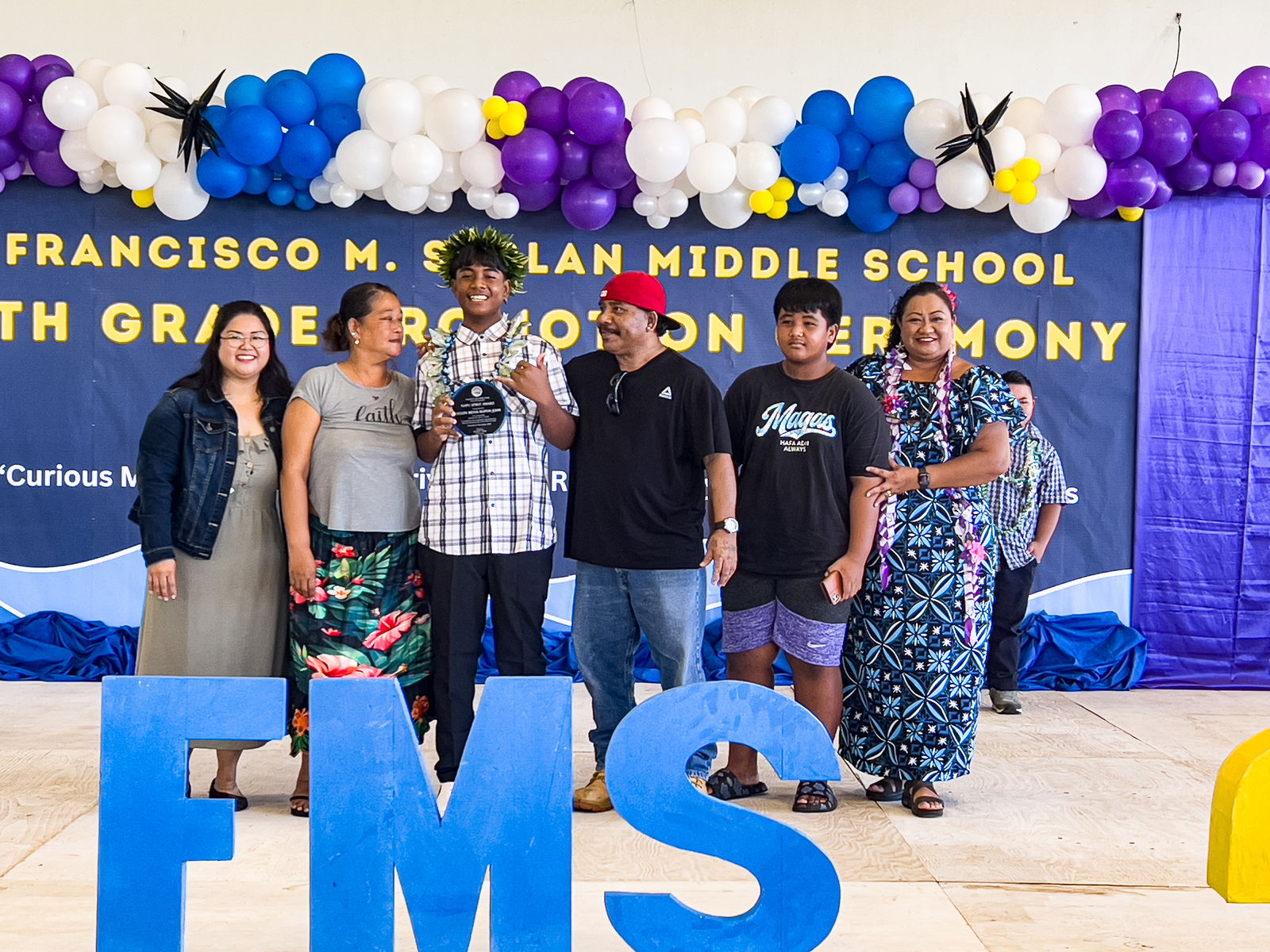 Kelvin Bryan Ropon John is one of the two Napu Spirit Award recipients. Also in photo are his family members and FMS Principal Cherlyn C. Osung and Vice Principal Catherin Cabrera.