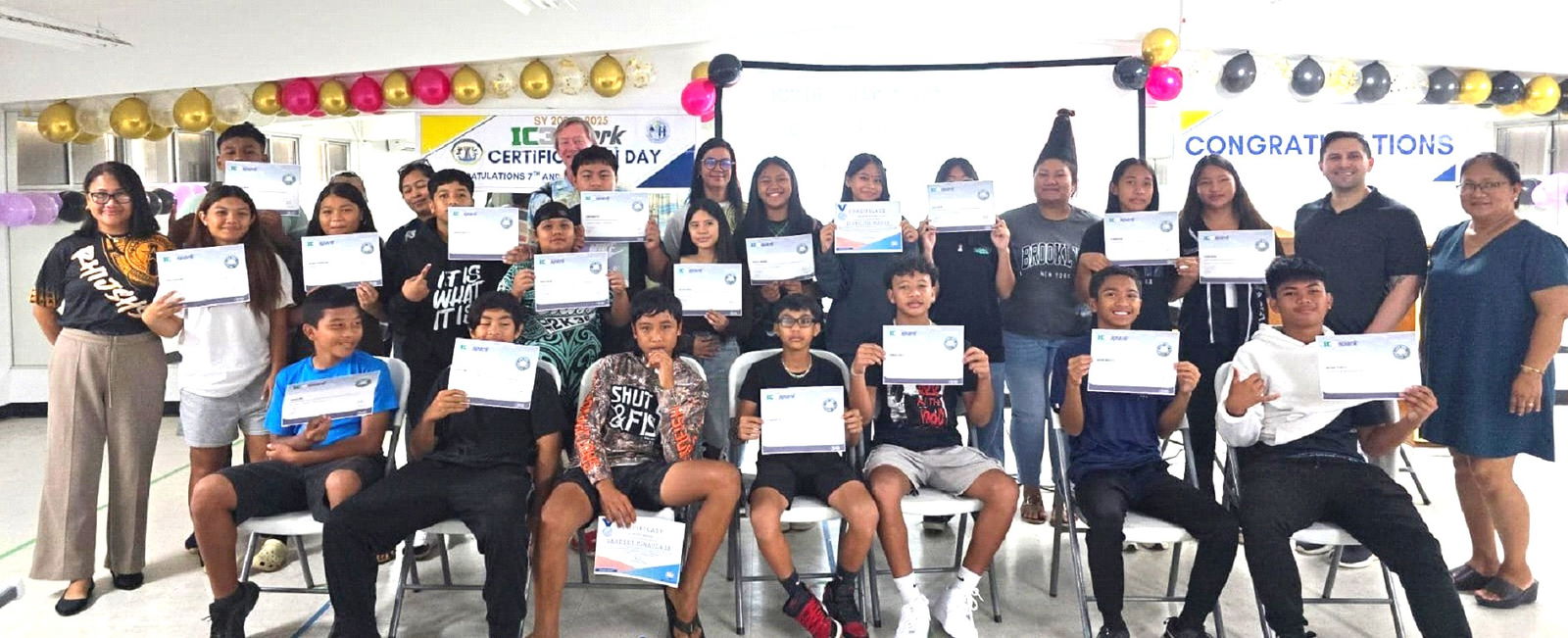 Dr. Rita Hocog Inos Junior/High School students display their IC3 Digital Literacy Spark certificates as they pose for a photo with RHI Principal Annette Calvo, right, RHI instructor Armi Atalig, left, and Island Training Solutions Chief Operating Officer Alex Hu, second right, at RHI on Rota, Thursday.Contributed photo