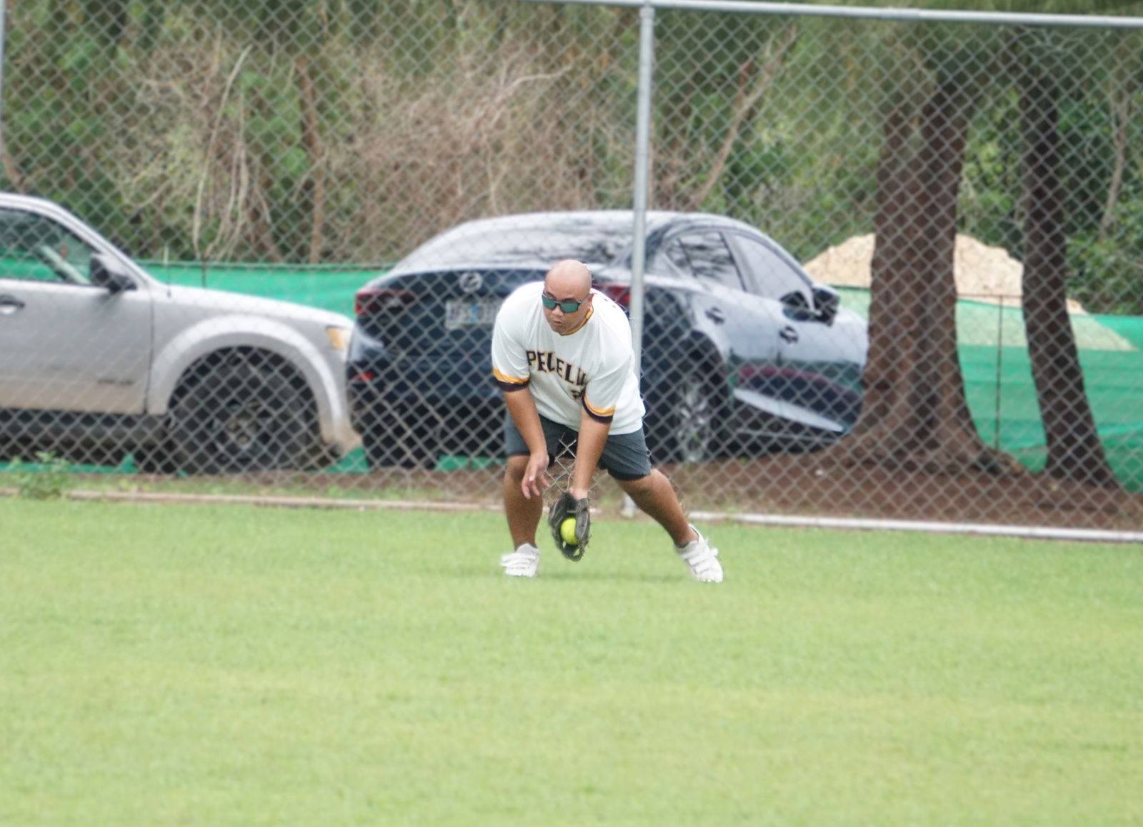 Peliliu centerfielder Shine Tenorio reaches to secure the ball during a game against Asahi in the masters division of the 2025 Belau Amateur Softball League at the Dandan ballfield on Sunday.Photo by James F. Sablan Jr.