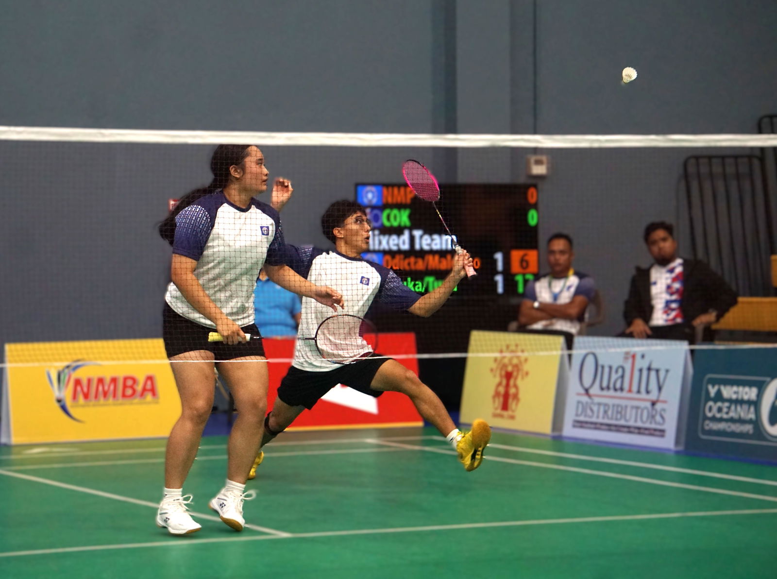 The NMI's Dave Odicta extends for the return alongside teammate Shaina Malonzo during a mixed doubles match against the Cook Islands in the VICTOR Oceania Junior Team Championships at the Ada gym.Photo by James F. Sablan Jr.