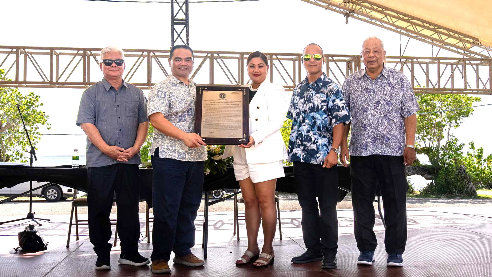 Gov. Arnold I. Palacios, left, and Lt. Gov. David M. Apatang, right, join Department of Lands and Natural Resources Secretary Sylvan O. Igisomar, second left, in receiving a framed copy of Senate Commemorative Resolution 24-2 from its co-authors, Sen. Corina Magofna and Sen. Ronnie Calvo, after proclaiming Fishers Recognition Week on Friday at the Garapan Fishing Base.Office of the Governor photo