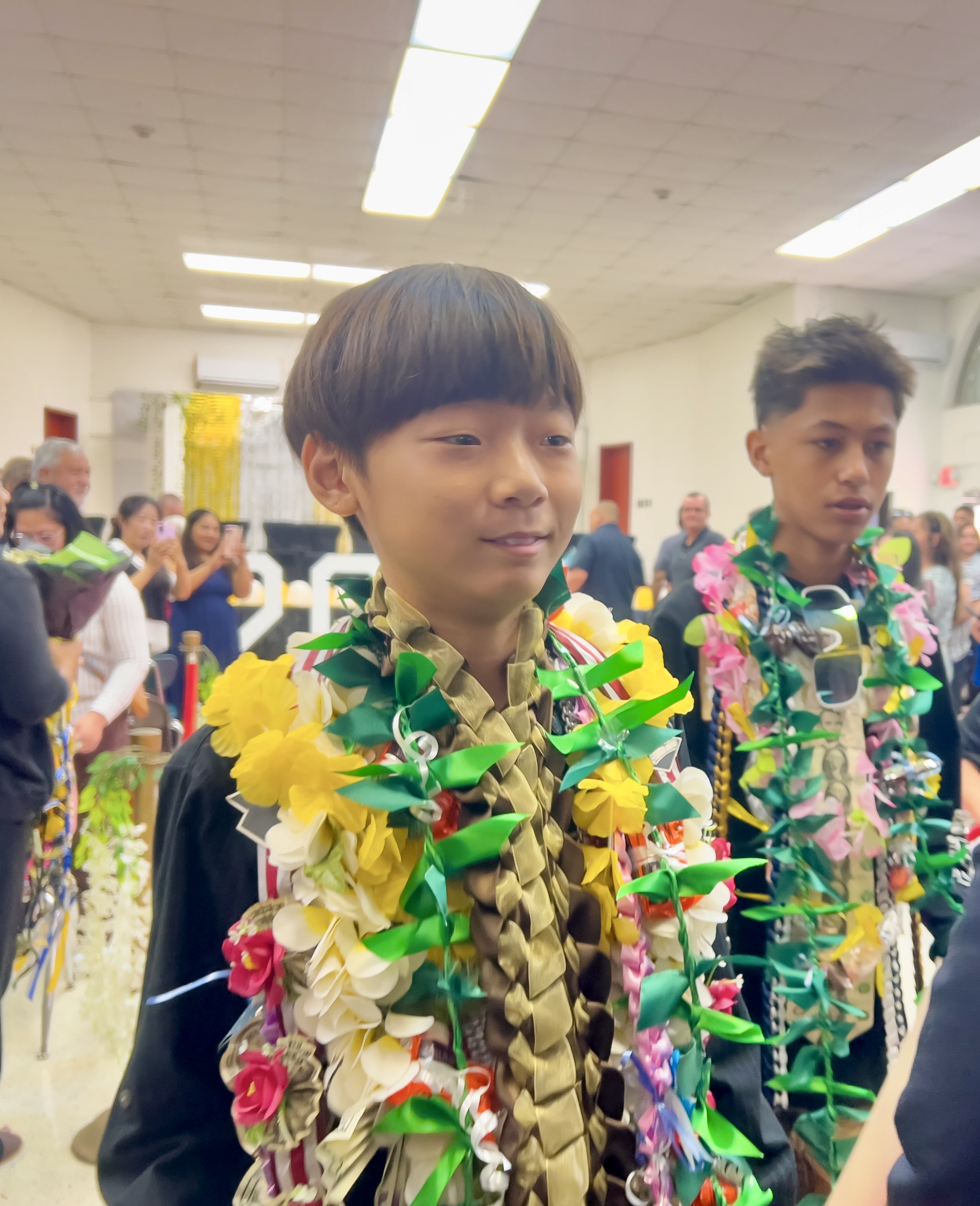 A Tinian Middle School promotee smiles at the conclusion of the ceremony.