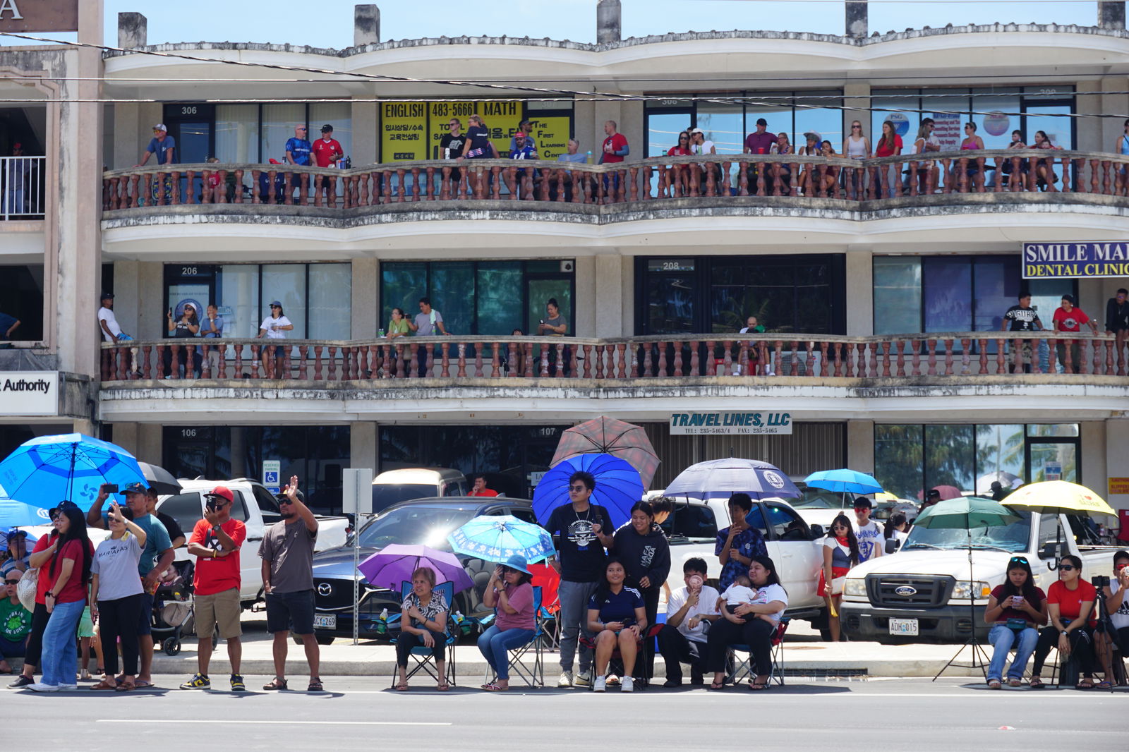Residents watch the parade pass by on Beach Road in San Jose. The new parade route began at Quartermaster Road and proceeded to the Civic Center area. 