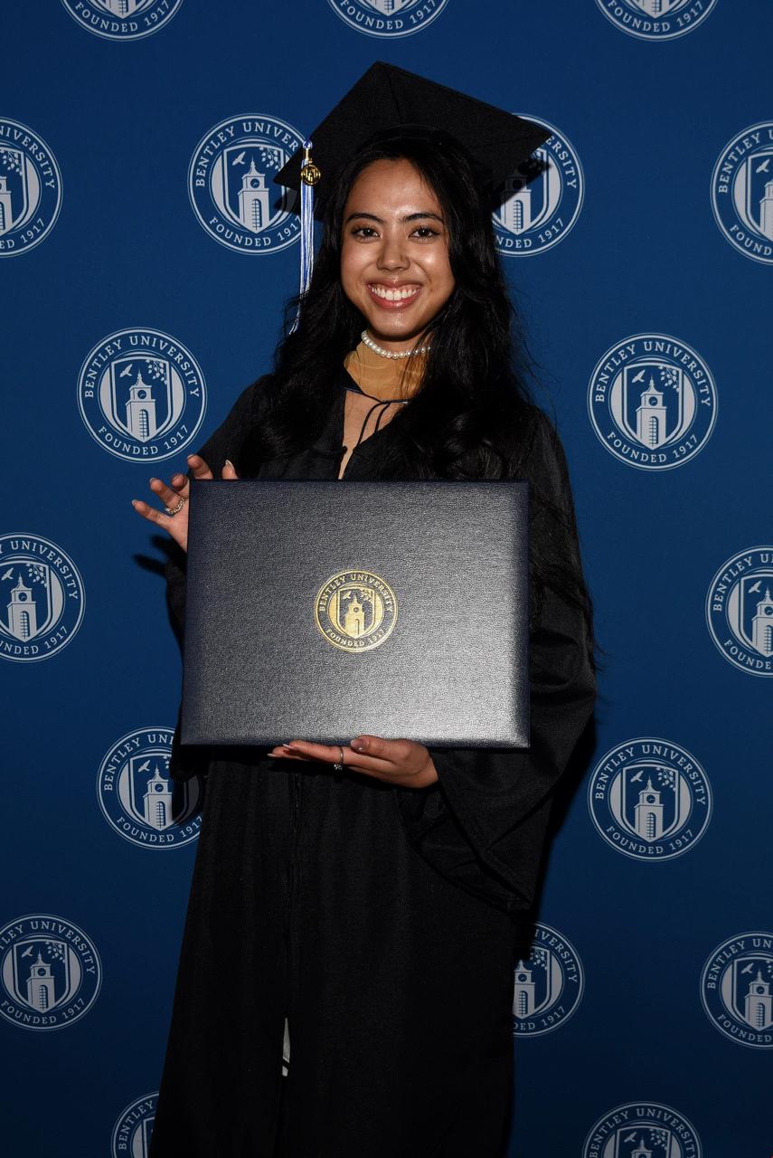 Maria Ayuyu smiles with her diploma.