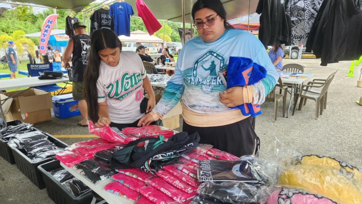 Festivalgoers peruse merchandise from local brand Hagu Real at the Saipan International Fishing Tournament festival on July 13, 2025, at Smiling Cove Marina.