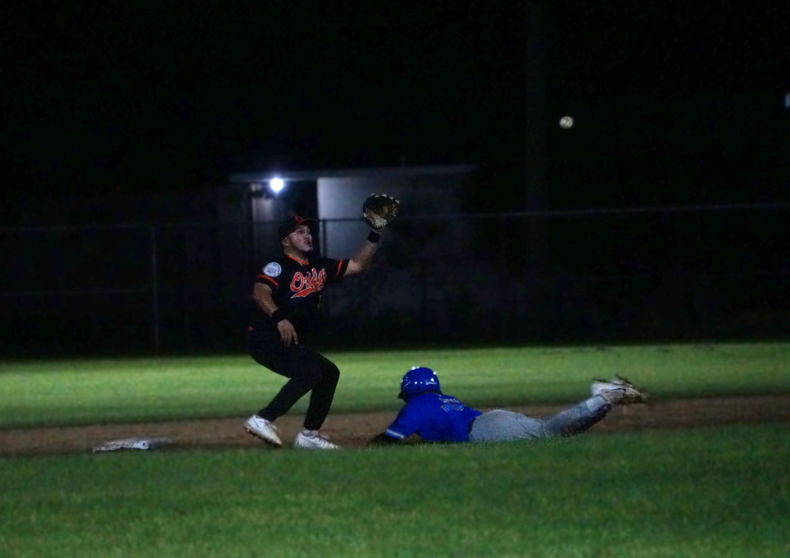 The Blue Jays’ Frankie Lieto slides into second base to beat a pickoff attempt during a game against the Orioles in the 2025 Saipan Baseball League at the Francisco “Tan Ko” Palacios Baseball Field on Monday night.Photo by James F. Sablan Jr.