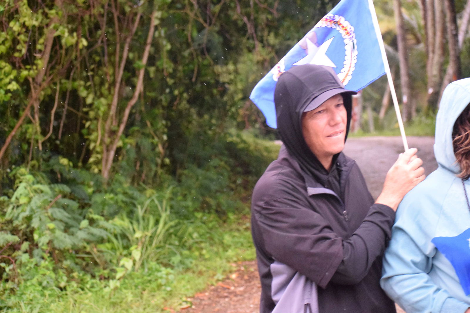 Dung Tenorio, holding a miniature CNMI flag, was among the Joeten family members who paid tribute to the late governor.