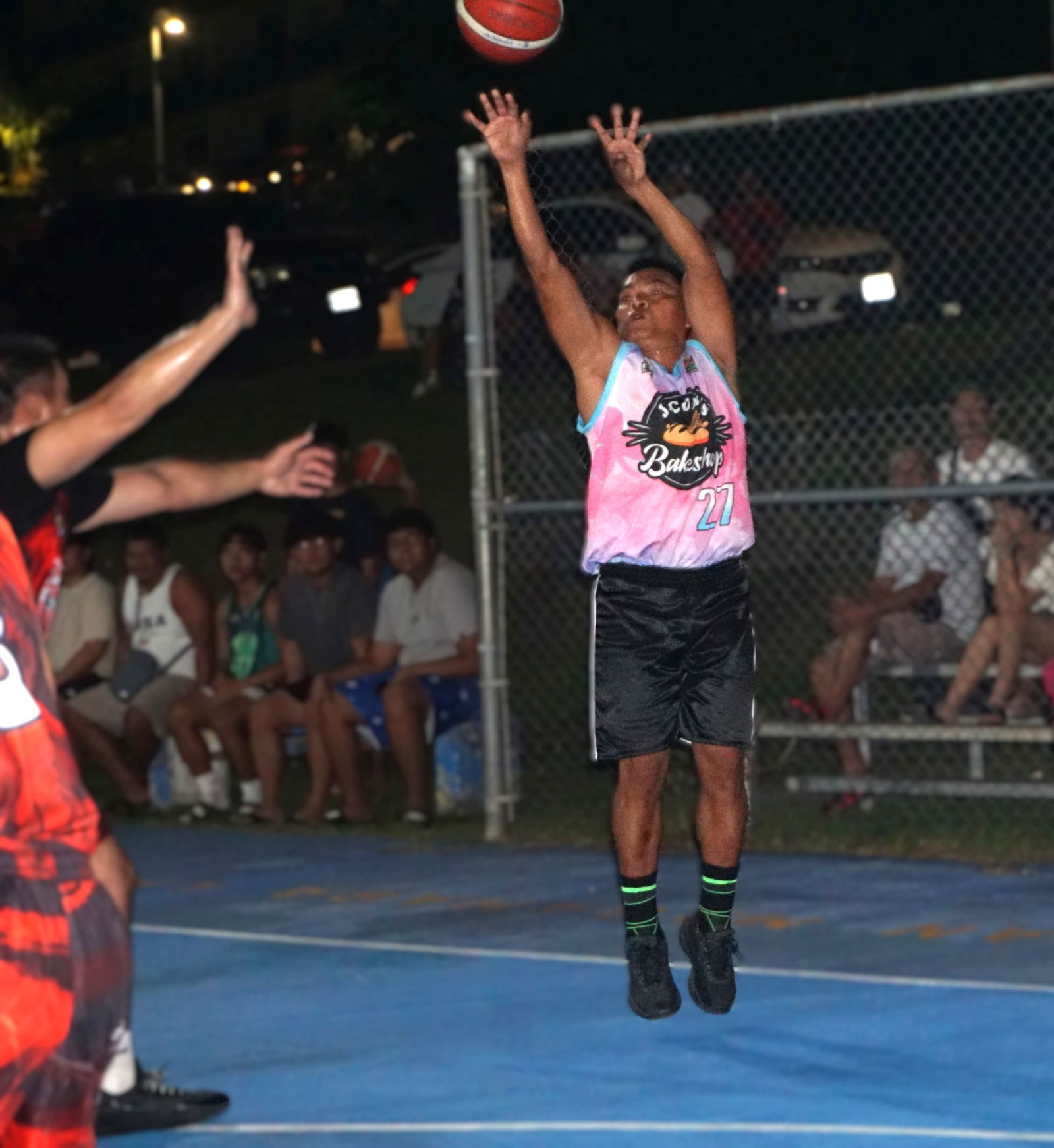 Vinz Rodriguez of Jacob’s Bakeshop pulls up for the contested three-point shot during a game in Bracket B of the E-Sports CNMI Invitational Basketball League 2025 at the Gualo Rai basketball court.Photo by James F. Sablan Jr.