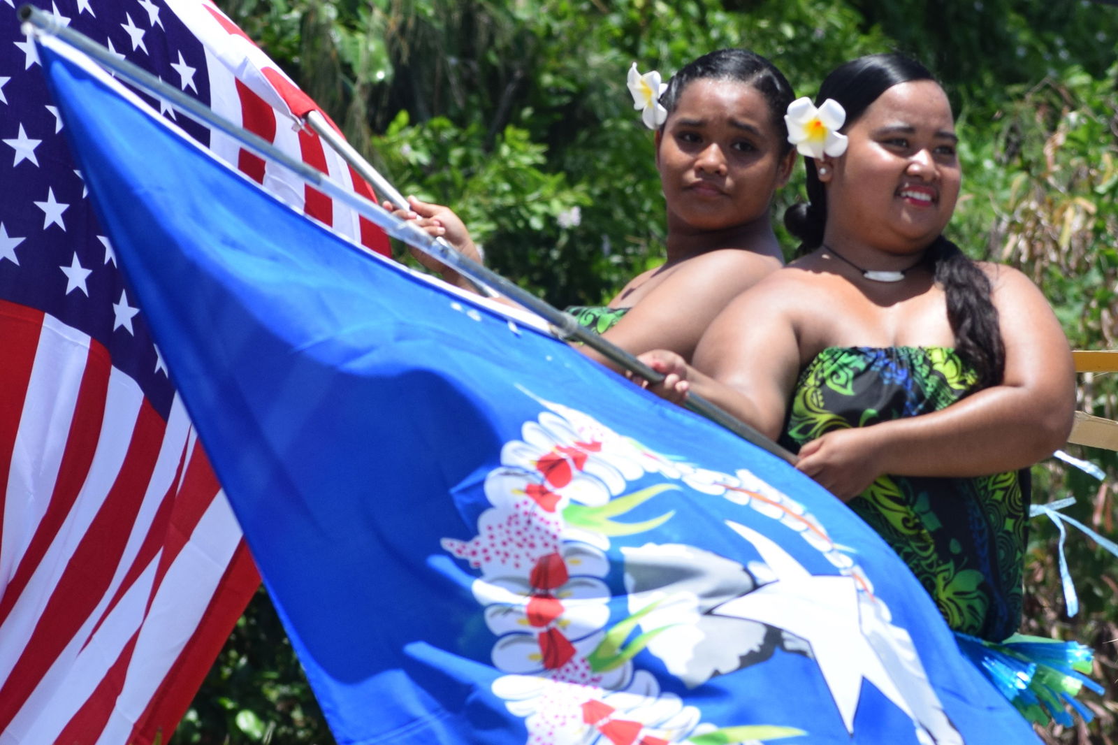 Liberation Day parade participants wave the U.S. and CNMI flags.