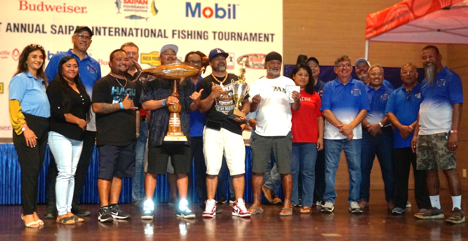 Mama Loling crewmembers pose alongside SFA board members as the first-place winner in the Yellow Fin category during the awards banquet for the Saipan Fishermen's Association's 41st Saipan International Fishing Tournament at the Taga Hall of Saipan World Resort on Monday night.