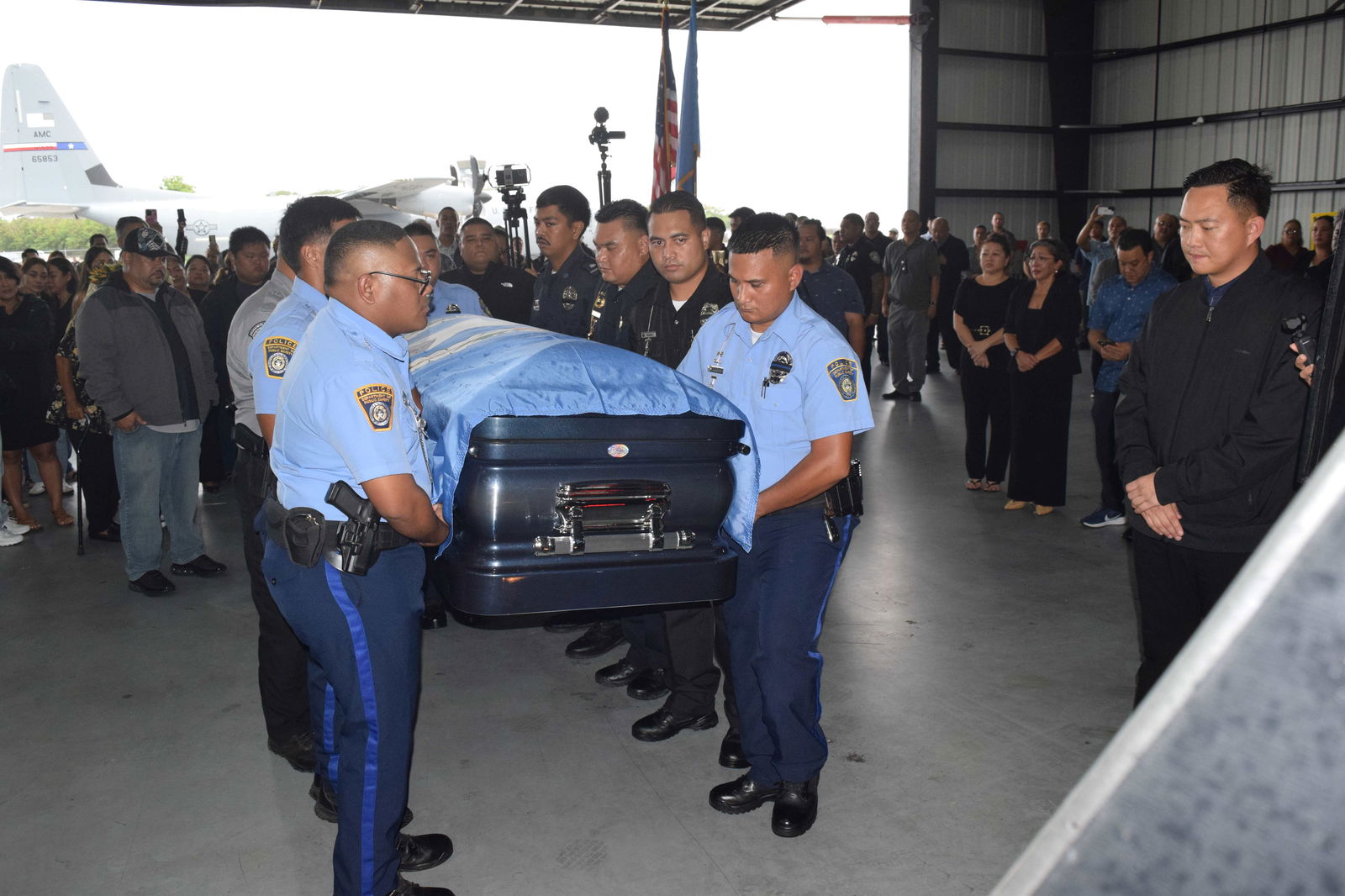 Department of Public Safety officers carry the late governor’s casket to the waiting hearse.