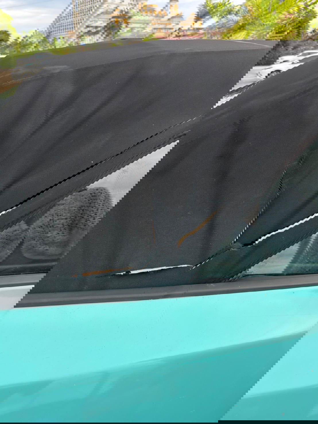 The torn hood of rental car of a Japanese social media influencer that was cut while they were filming at Obyan Beach on July 20, 2025, as part of their work with the Marianas Visitors Authority to promote the Marianas.