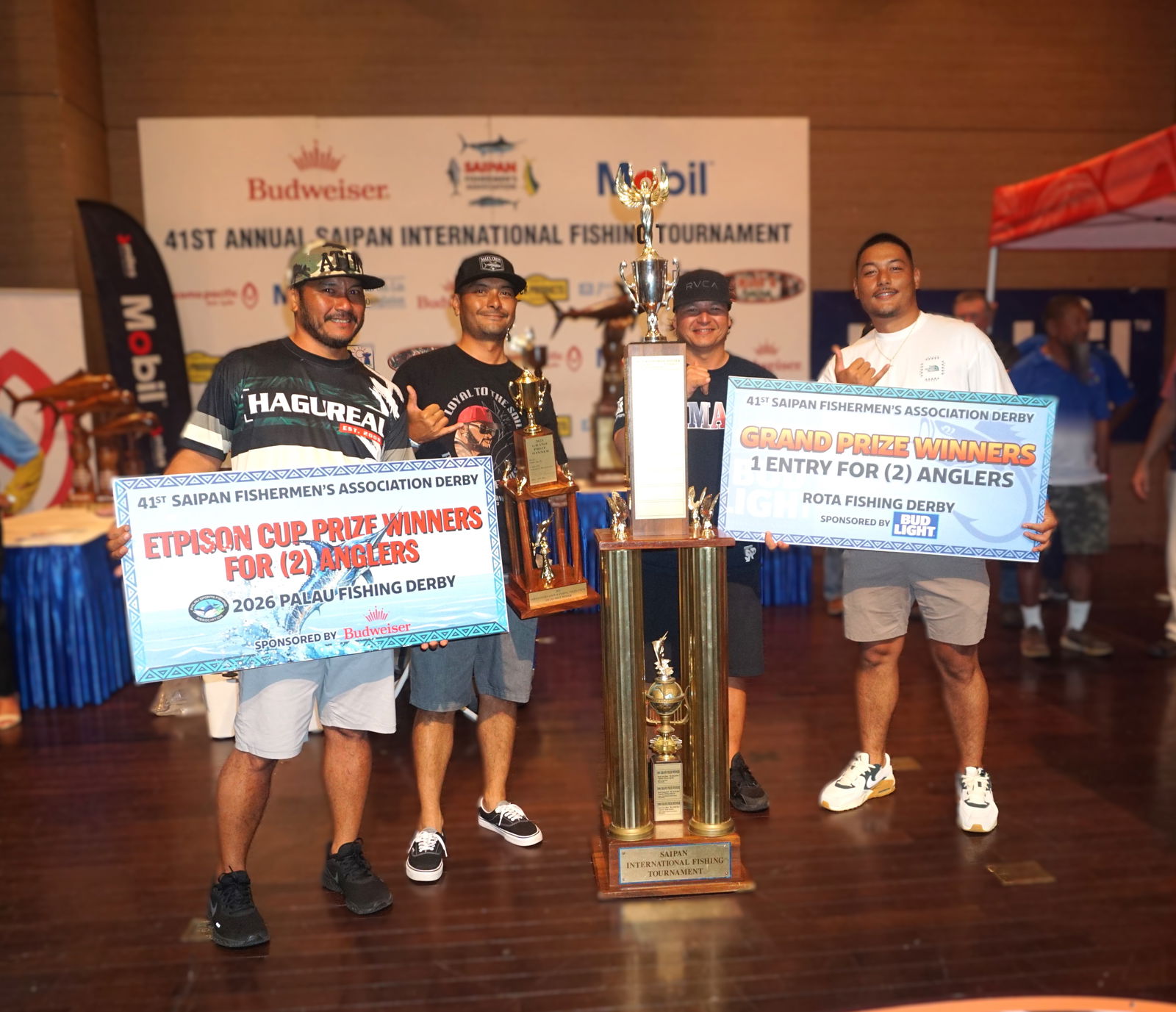 The grand​ prize winners — Only Reels’ Captain Aaron Benavente, Anthony Benavente, Jesse Ramon, and Austin Benavente — pose with their trophies and prizes during the awards banquet for the Saipan Fishermen's Association's 41st Saipan International Fishing Tournament at the Taga Hall of Saipan World Resort on Monday night.