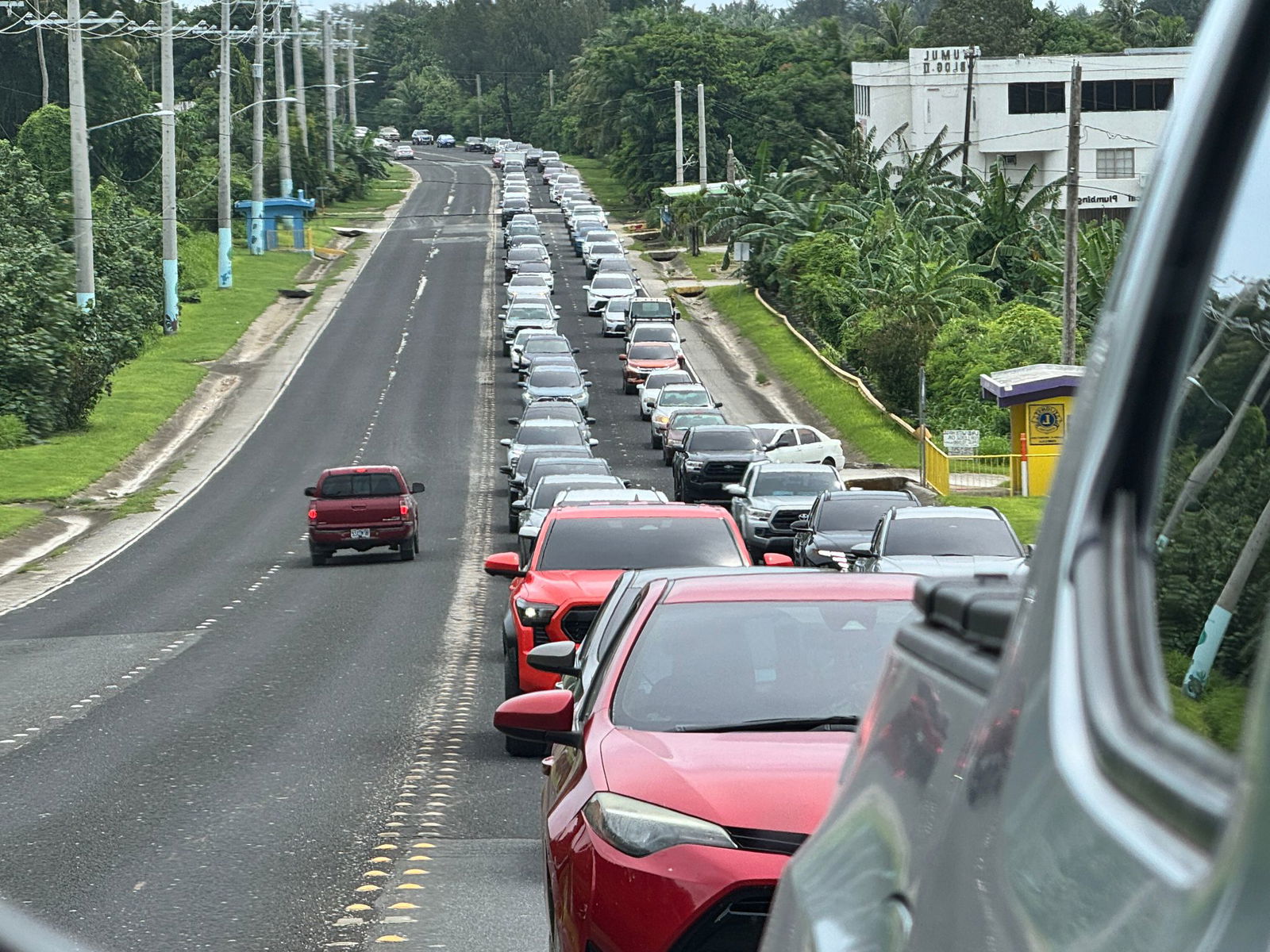 At 2:06 p.m. Wednesday, a reverse mirror photo captures vehicles making their way up As Terlaje Hill.Contributed photo