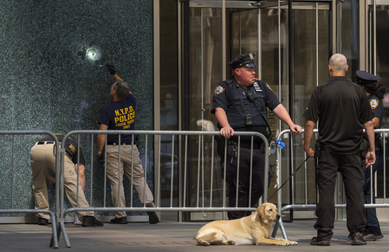 Members of the NYPD Crime Unit examine a door with bullet holes at the scene of the previous day’s deadly shooting, Tuesday, July 29, 2025, in New York.AP