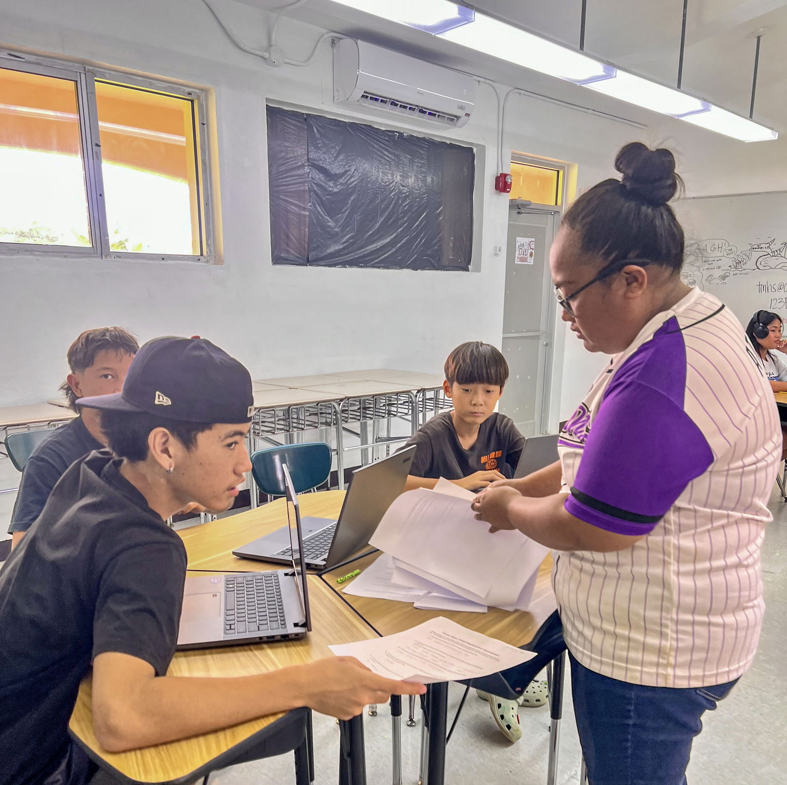 Teacher Thealanie Atalig guides her Tinian Middle School students through an activity.