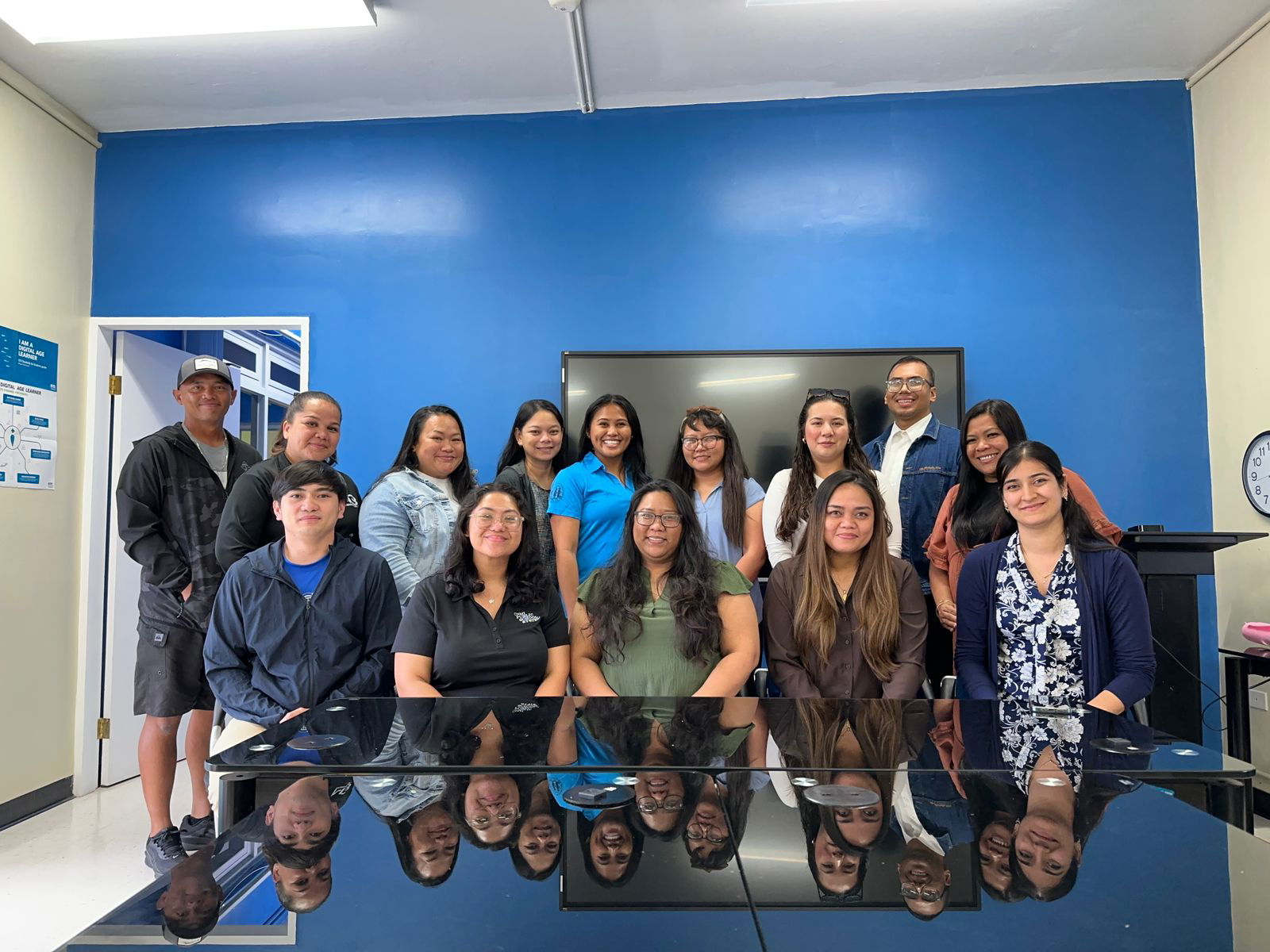 The Instructional Technology and Distance Education Program team of the Public School System led by Dr. Lorraine Catienza, seated center, received  two national distinctions for education technology innovation and artificial intelligence integration.