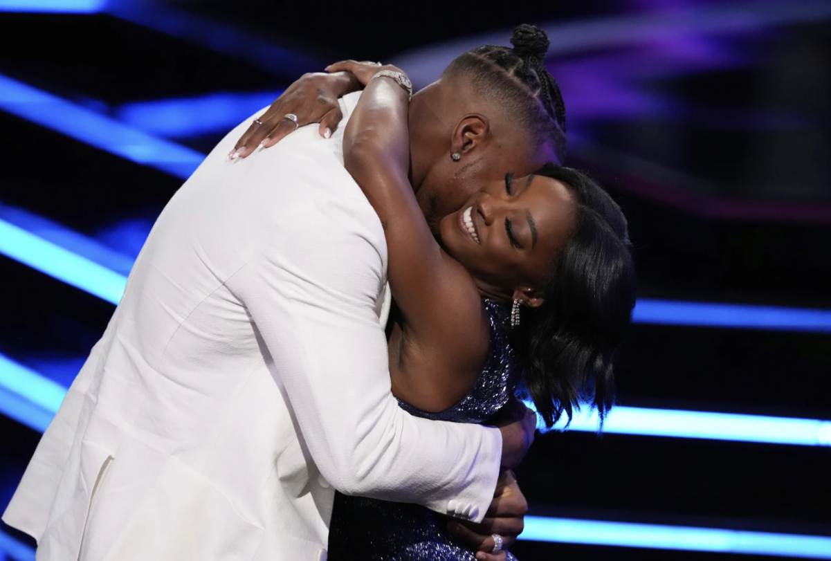 Simone Biles, right, hugs Jonathan Owens while accepting an award at the ESPY Awards at the Dolby Theatre in Los Angeles, Wednesday, July 16, 2025.AP