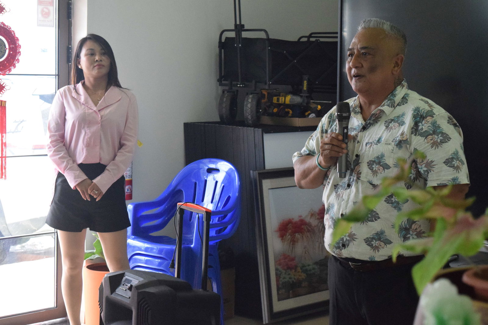 Saipan Green Energy business associate Joe Palacios delivers his remarks as owner Stacy Wang listens.