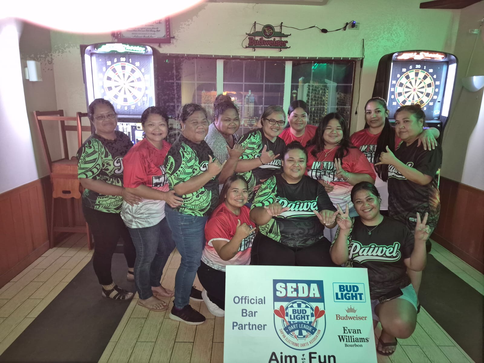 Bistro Paiwel and XXX In The Middle pose for a group photo after their match in the ladies division of the 2025 SEDA Bud Light Dart League at the Bistro in Garapan on Monday night.Contributed photo