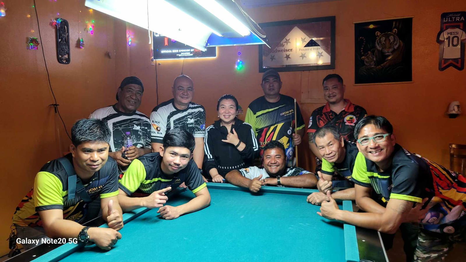 Tom Yum Yummy and Black 8 Rack N Roll players pose for a group photo after their match in the Thursday Division of the 2025 SBA Budweiser Open 8-Ball League at Tom Yum Restaurant on Thursday last week.Contributed photo