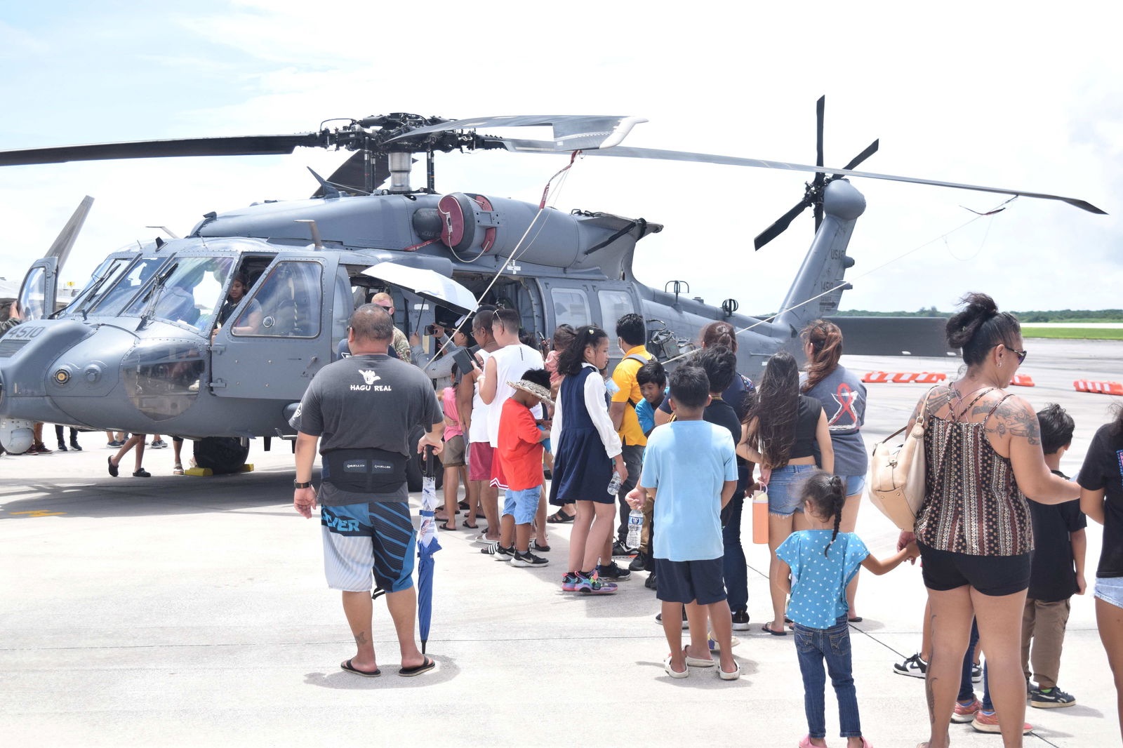 Saipan residents line up for a chance to board the HH-60 search and rescue helicopter during Resolute Force Pacific 2025’s Community Day.