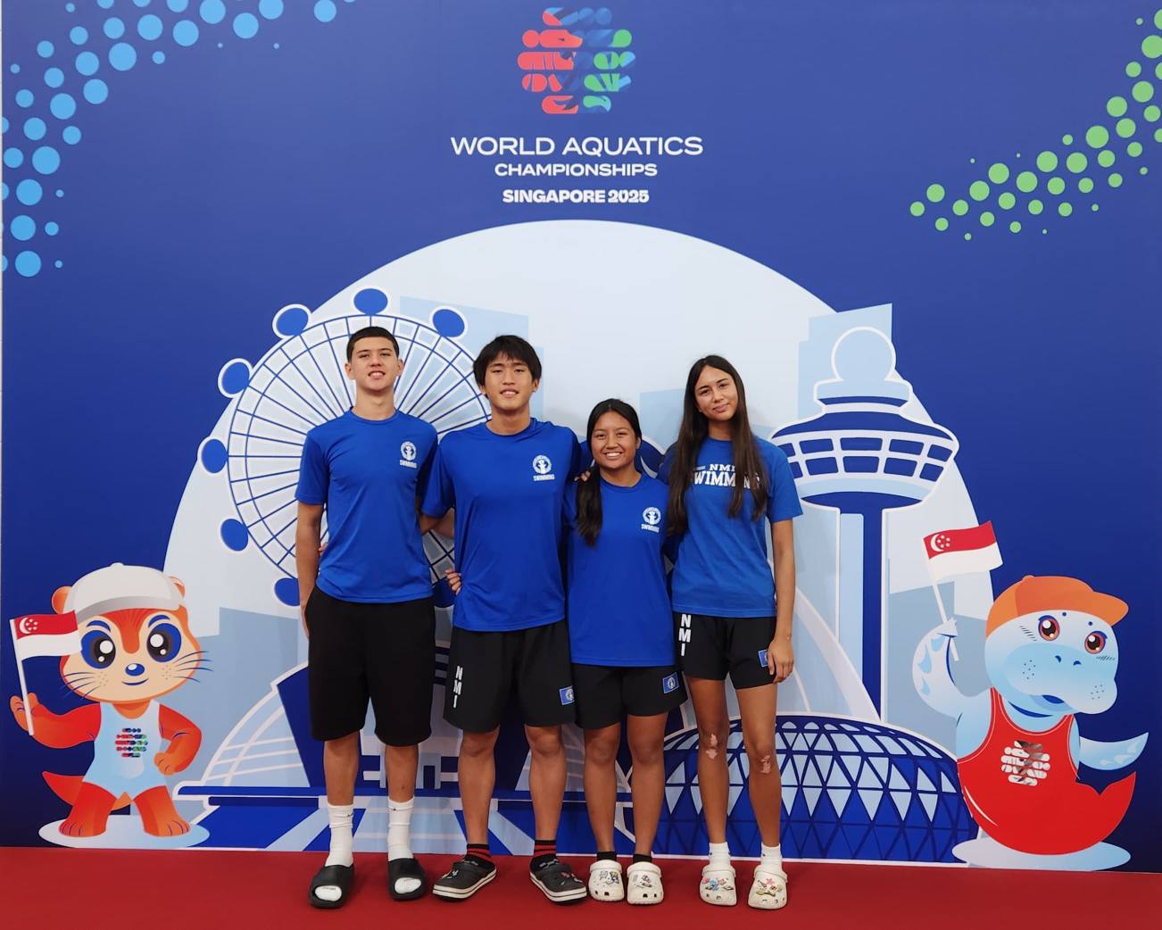 Michael Miller, Kouki Watanabe, Maria Batallones, and Piper Raho pose for a photo at the 2025 World Aquatics Championships in Singapore.NMI Swimming Facebook page