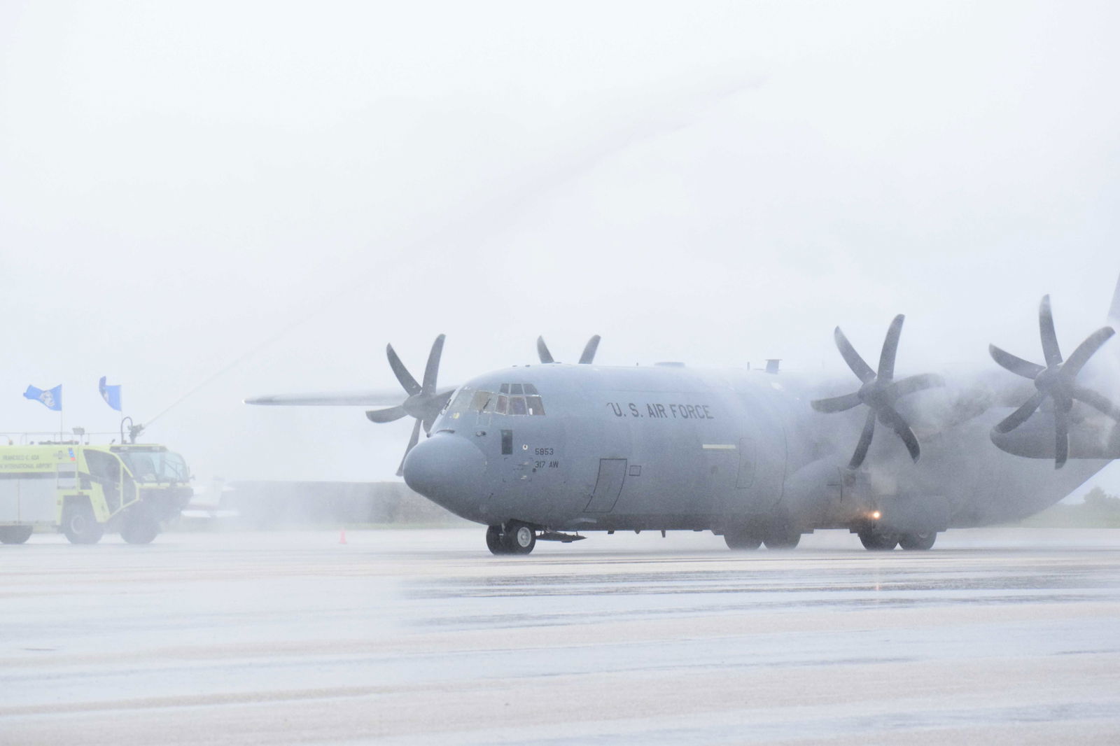 A U.S. Air Force C-130 carrying Gov. Arnold I. Palacios’s remains receives a water cannon salute from the Department of Fire and Emergency Medical Services.