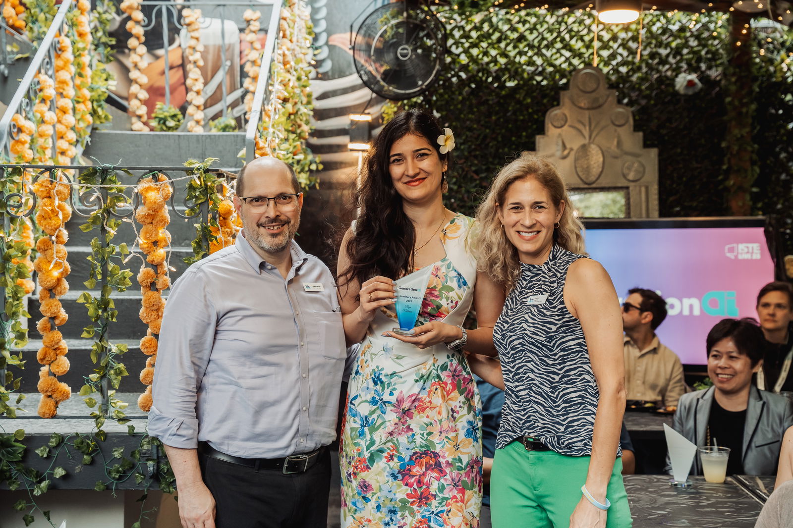 Dr. Riya Nathrani, center, receives the GenerationAI Luminary Award.