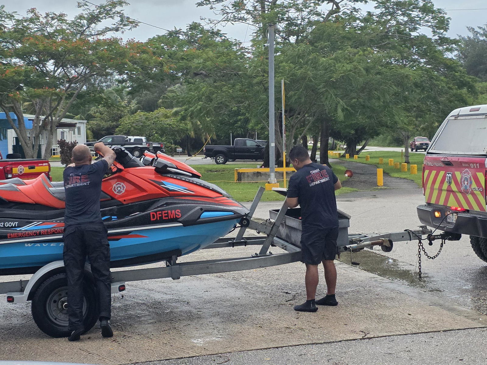 The two DFEMS personnel with the jet skis they used to rescue the surfer early Sunday evening.Photo by Bryan Manabat