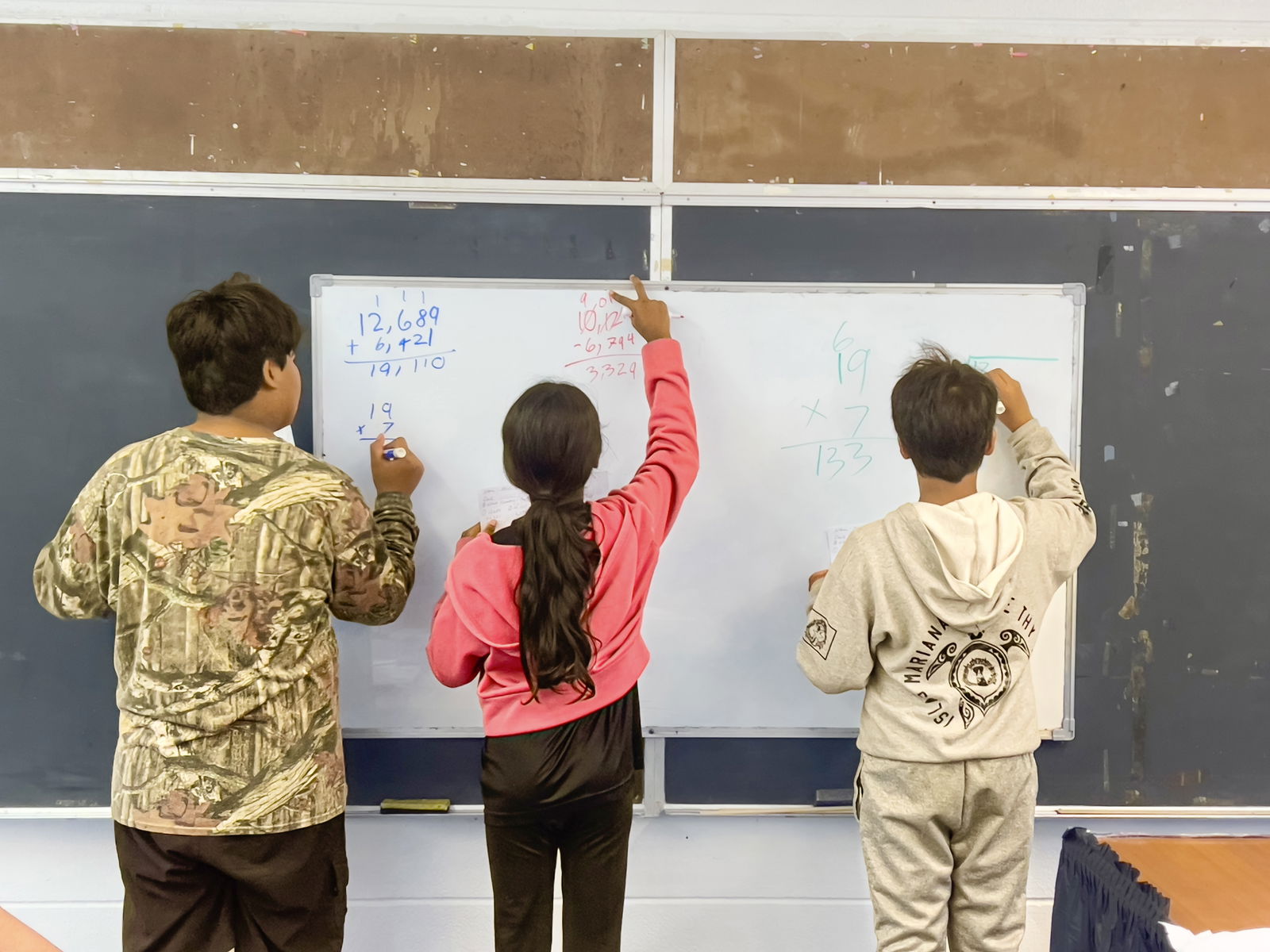 Three students of Tinian Elementary School teacher Alicia Oliva demonstrate their mastery in mathematics on Friday as part of the summer enrichment program. The Public School System has implemented this program for over a decade to provide continuous learning for elementary, middle, and high school students as they transition to the next grade level.PSS photo